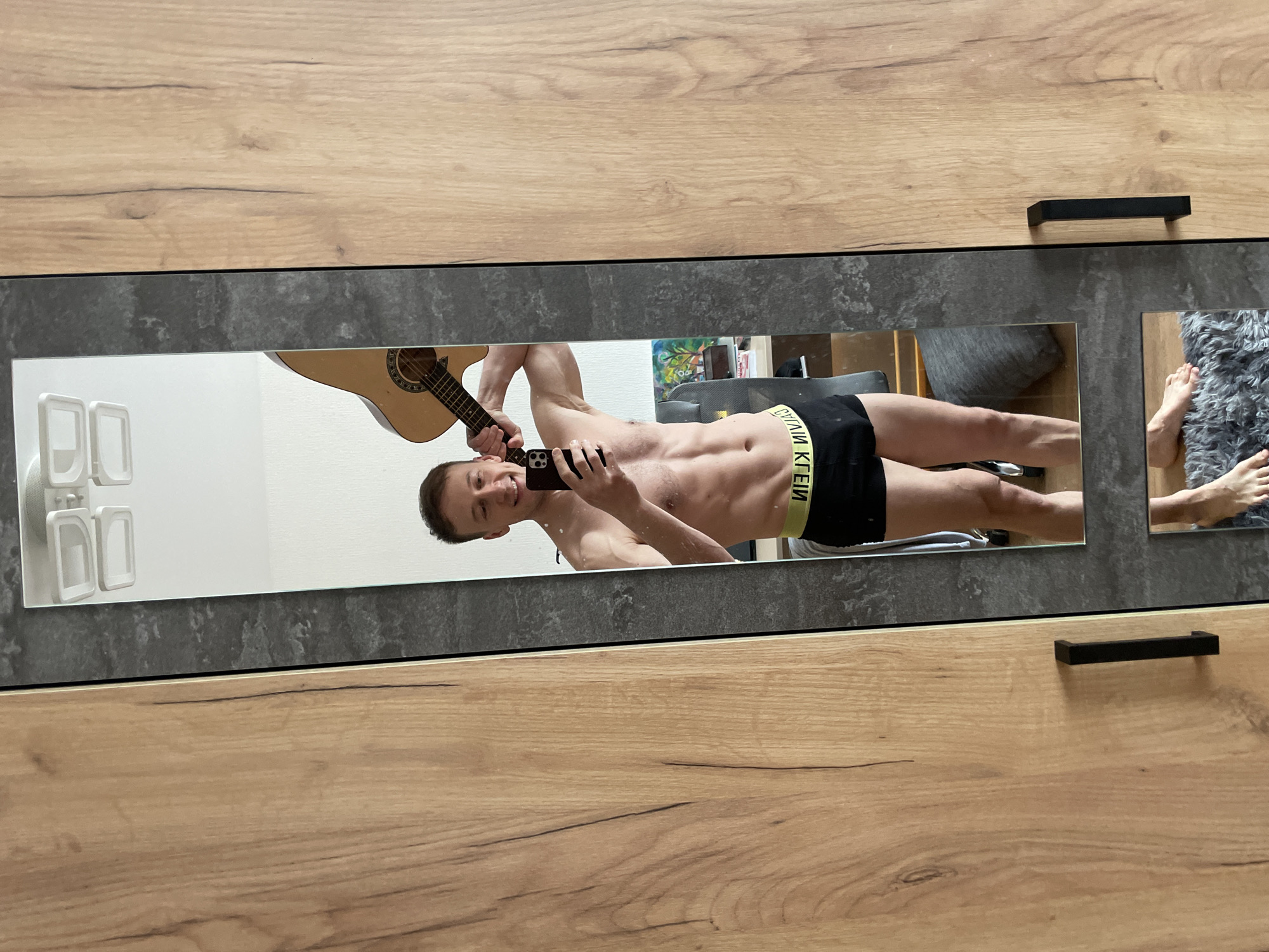 Man takes mirror selfie in Russian indoor location