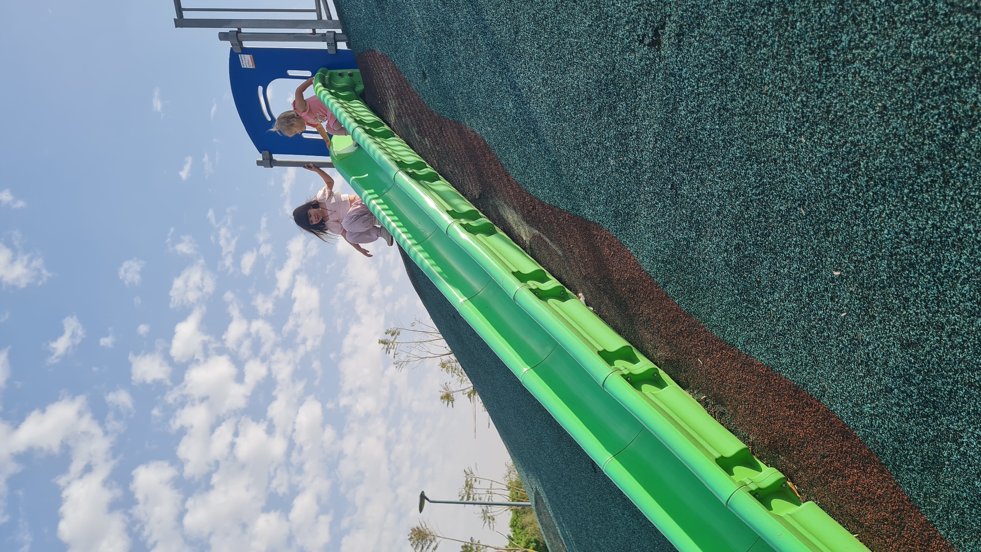 Children play at Kiryat Gat playground on sunny afternoon