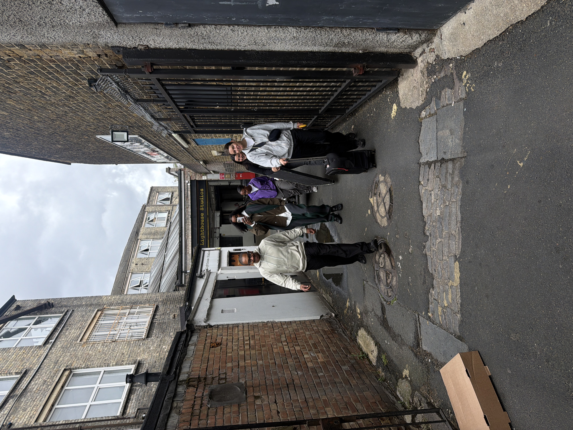 Young adults film photoshoot in Hackney alleyway Wednesday morning