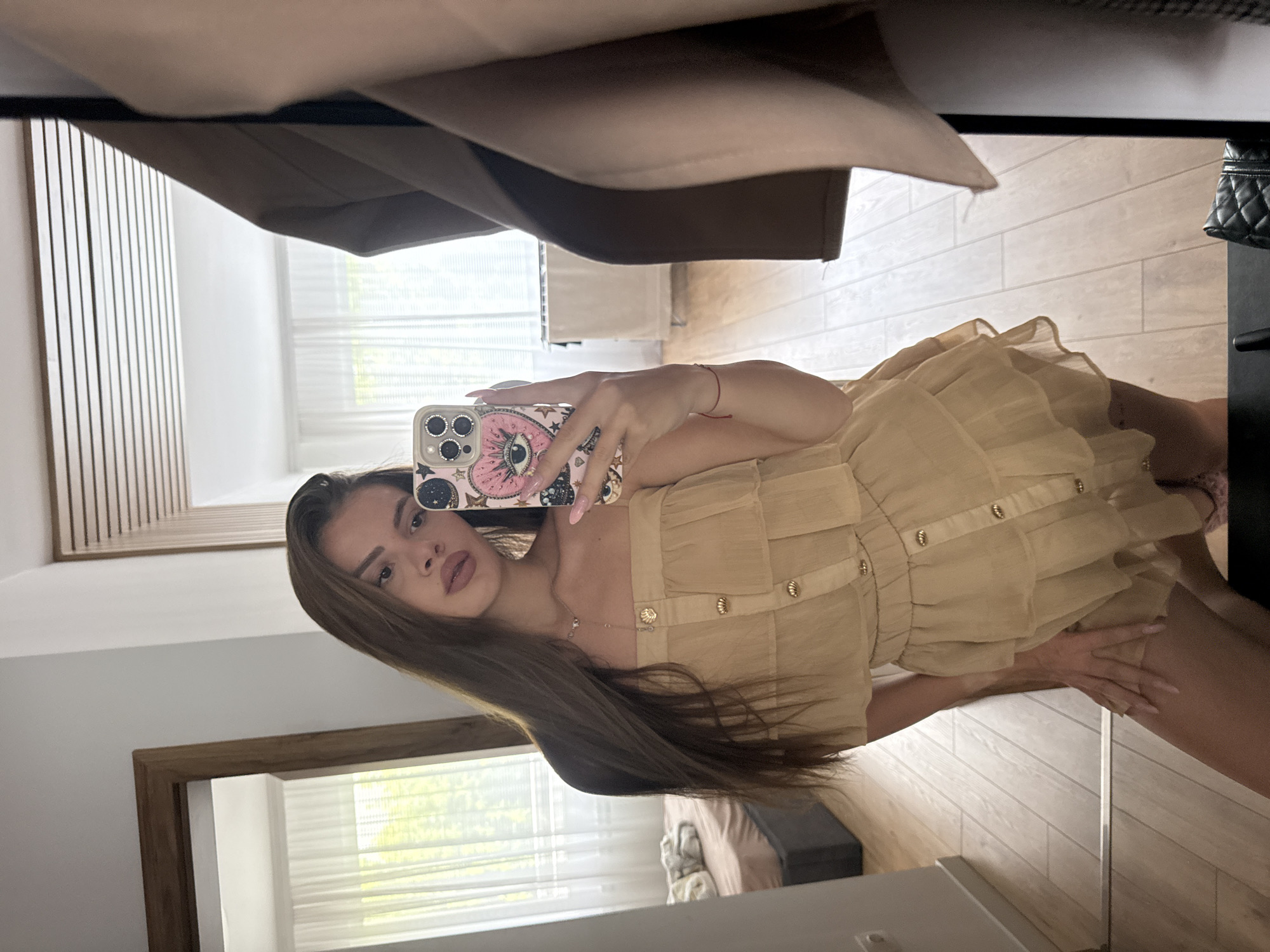 Woman takes sideways mirror selfie indoors
