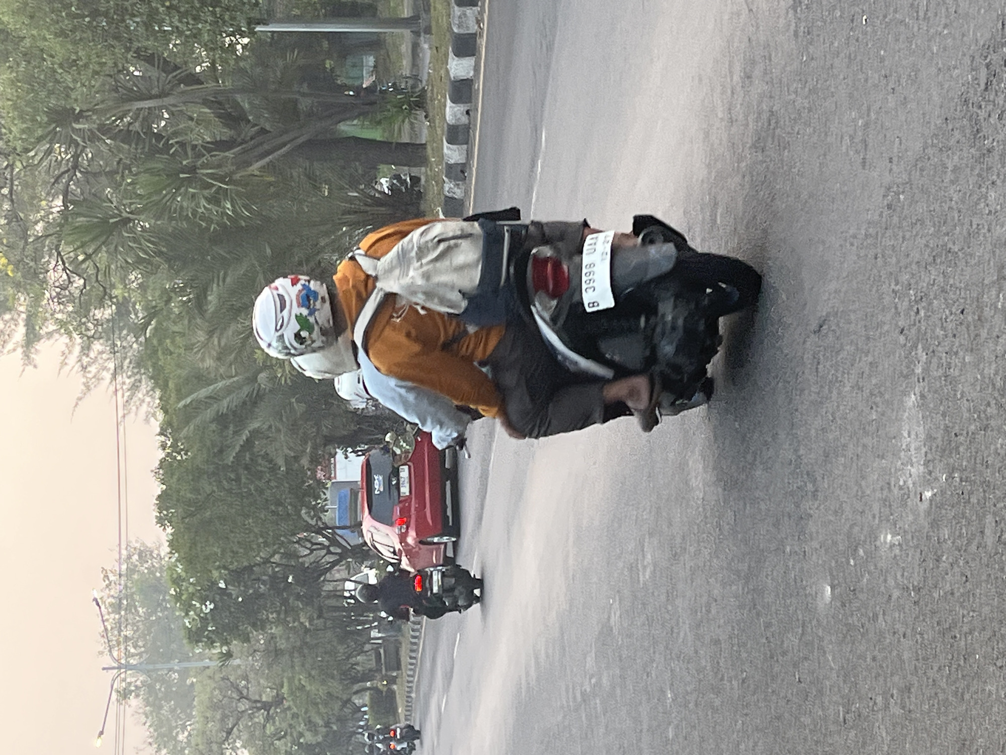 Dense motorcycle traffic flows through East Java streets at night