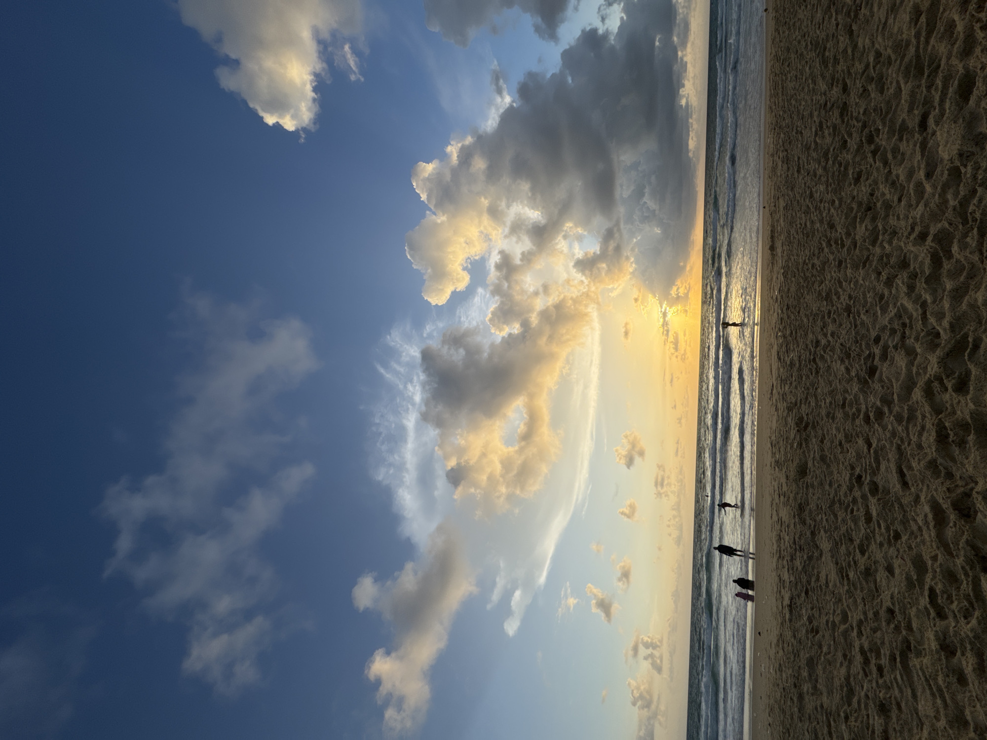 Sunset hour at Karon Beach, clouds and warm light over the water