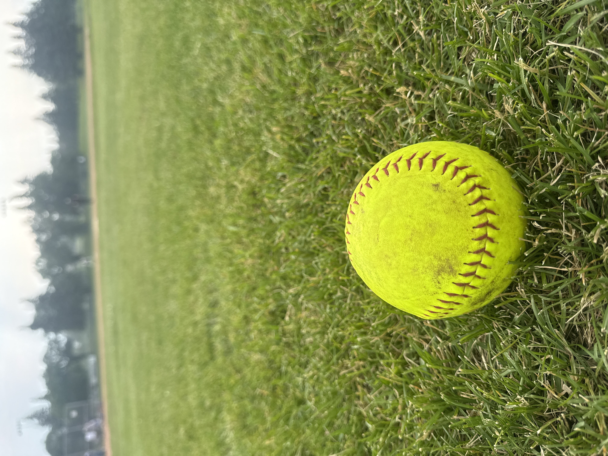 Casual softball game on a cloudy Canada Day evening