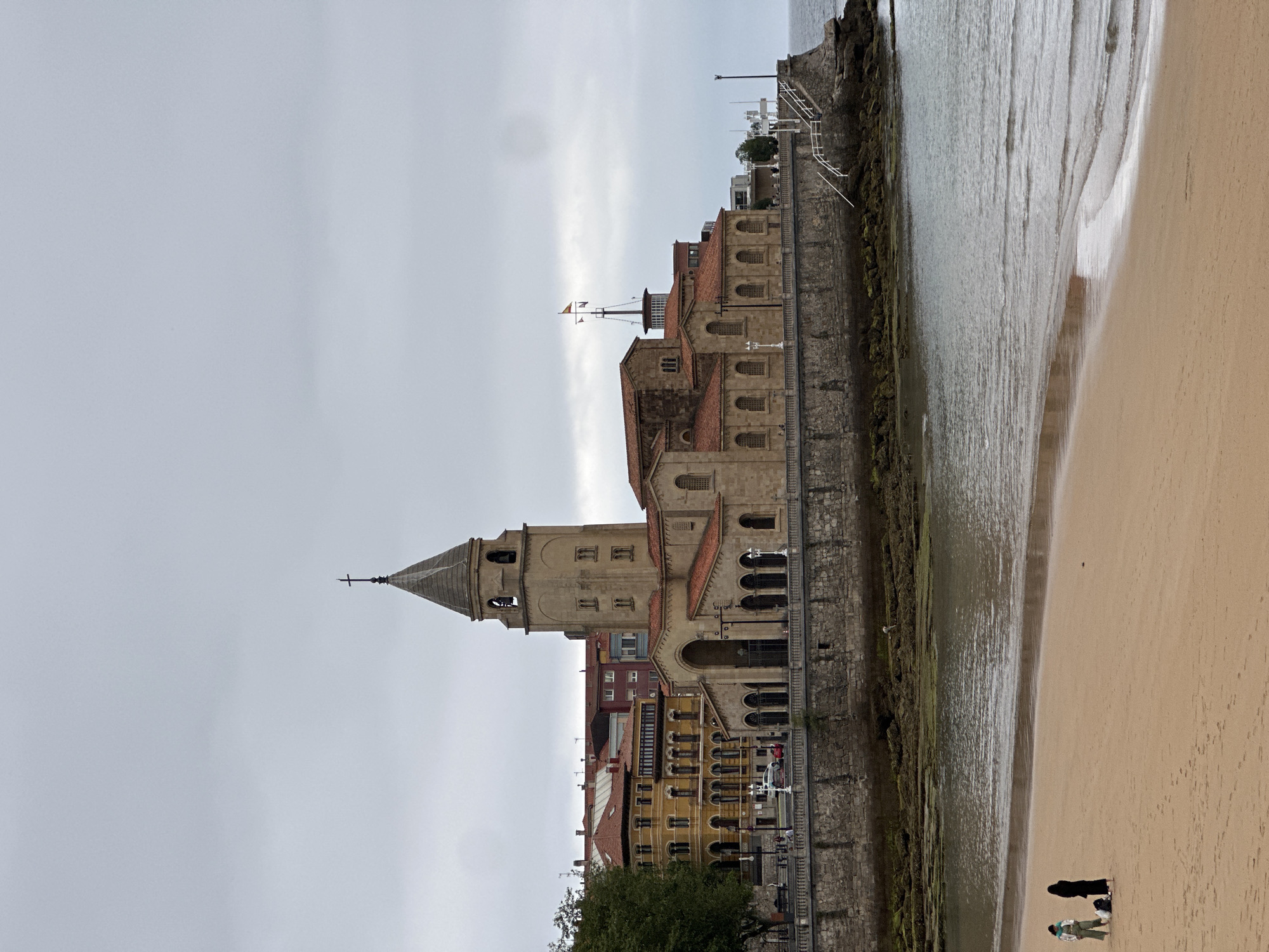 Witness documents historic architecture in Gijón, Spain under cloudy skies