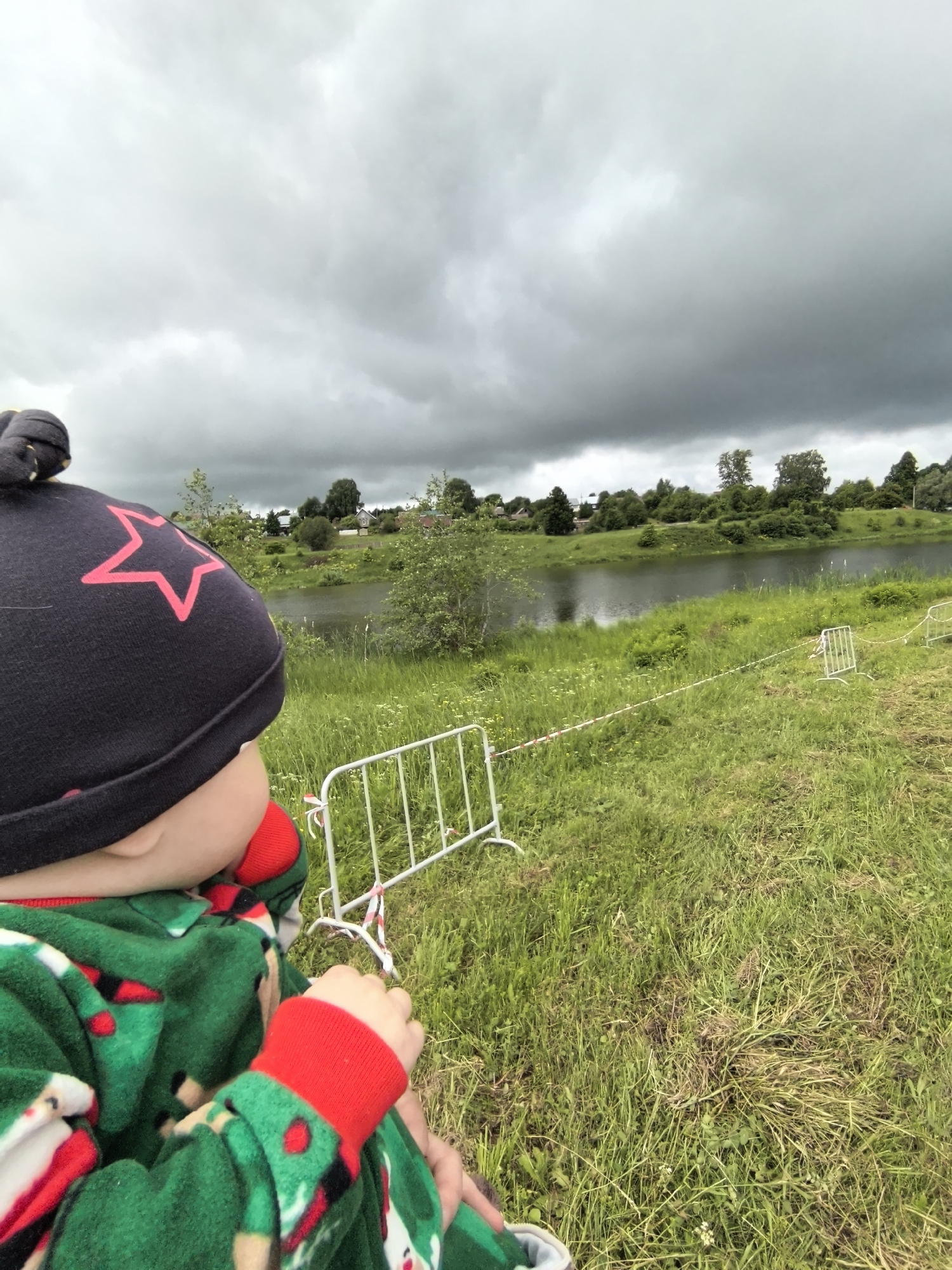 Child observed under overcast sky near Russian parking area