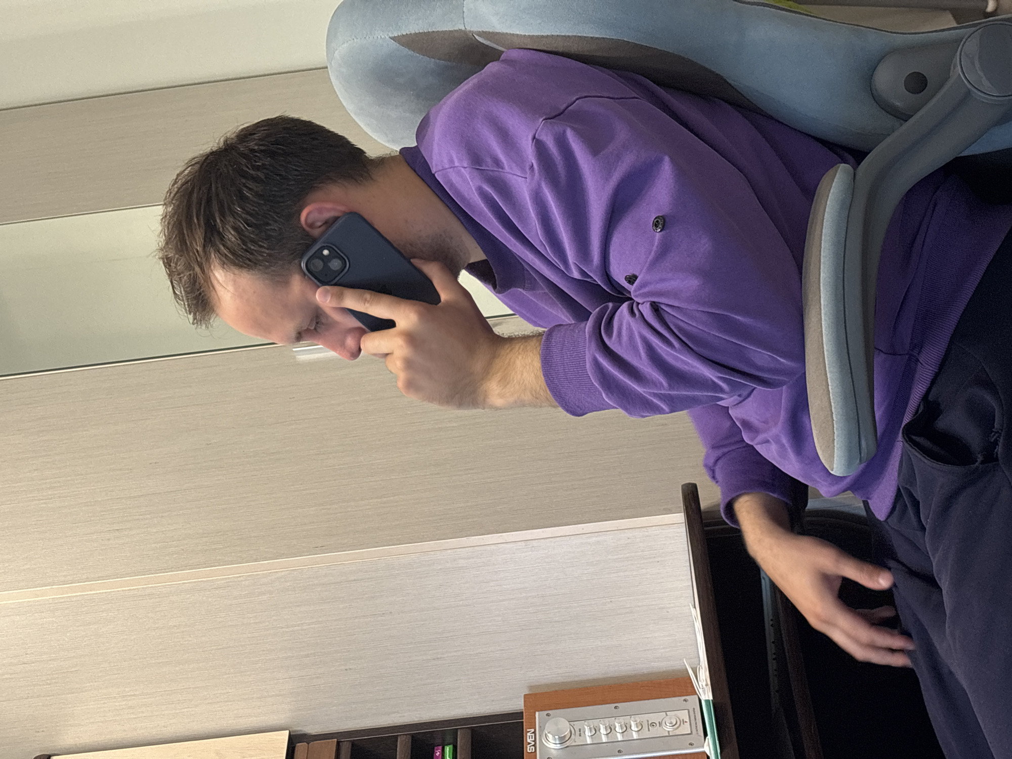 Man in purple sweater observed indoors in Rusanovo
