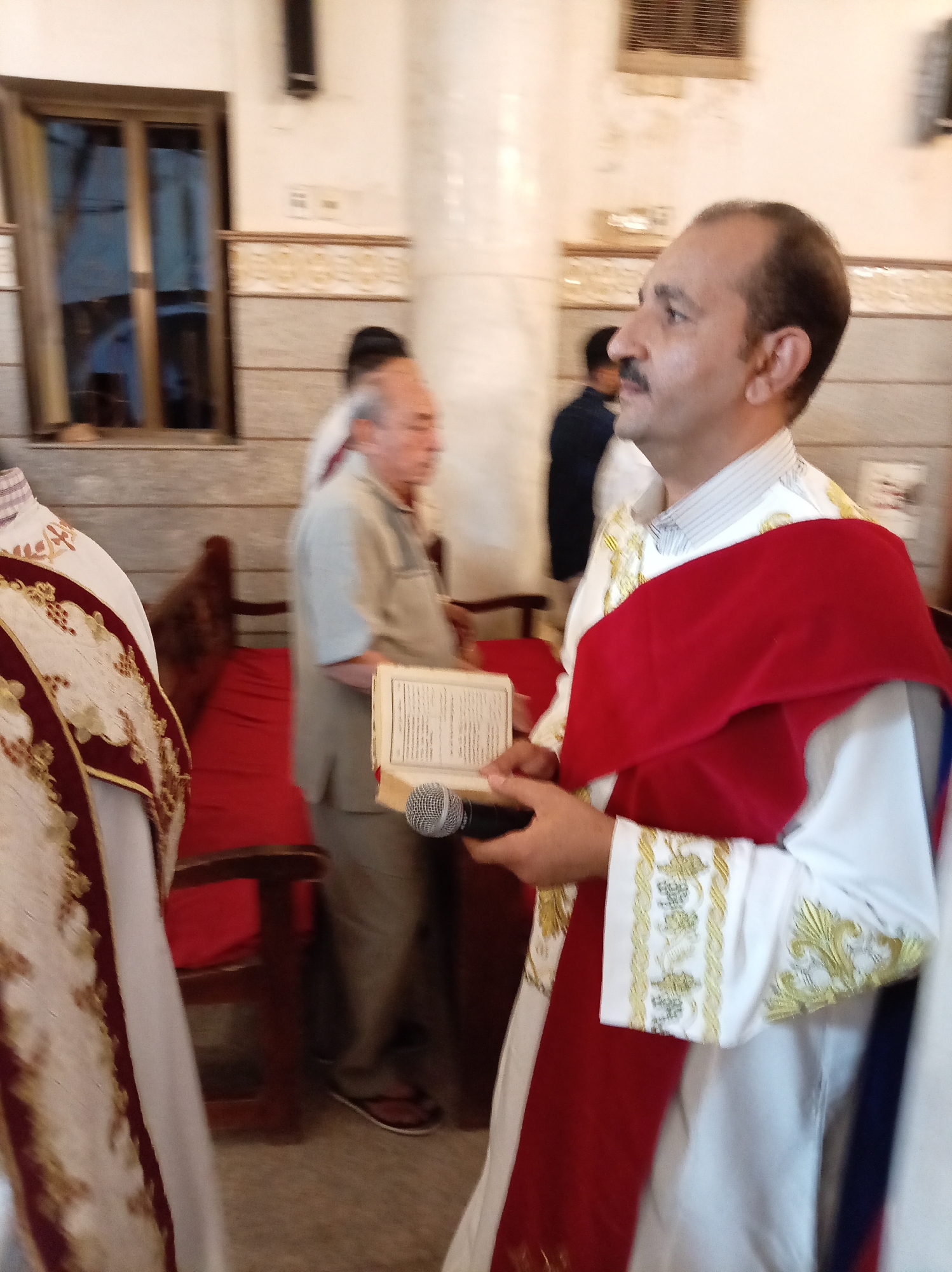 Orthodox clergy conduct religious service in ornate church