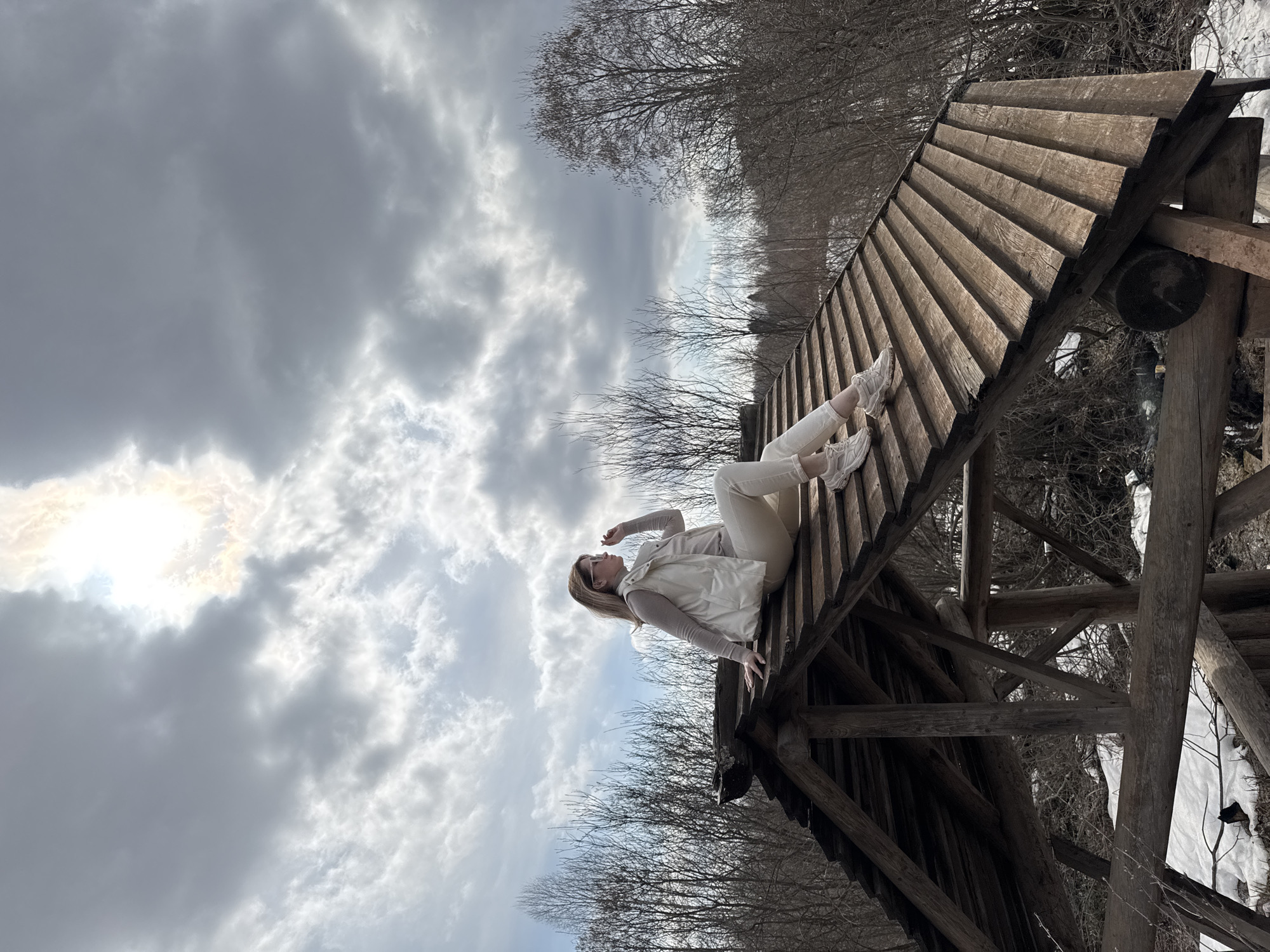 Woman climbs wooden structures in rural Russian village