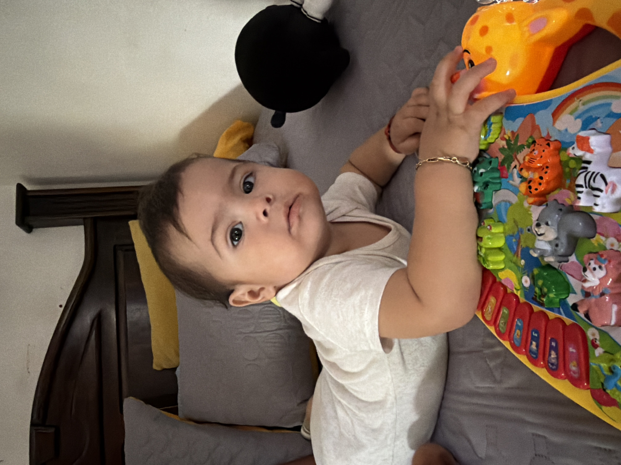 Baby rests on bed in Reforma, Mexico