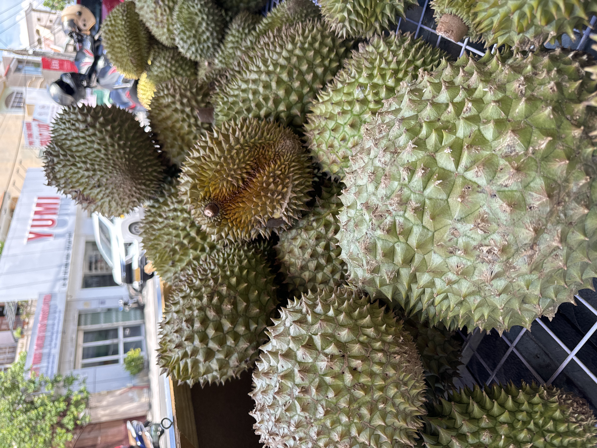 Durian stall scene at a Phan Thiết roadside market