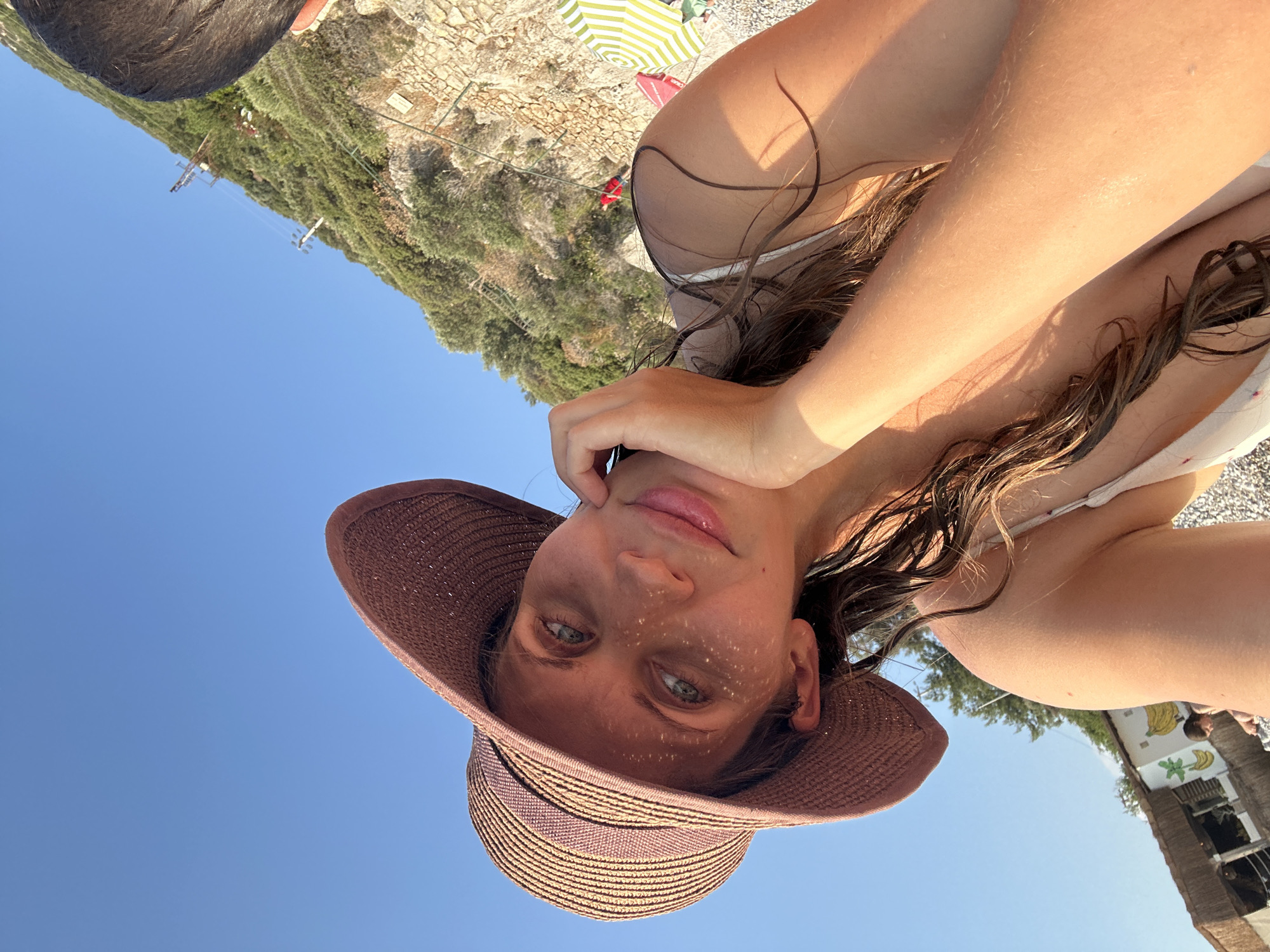 Paragliders soar over Fethiye's Ölüdeniz beach during sunny afternoon