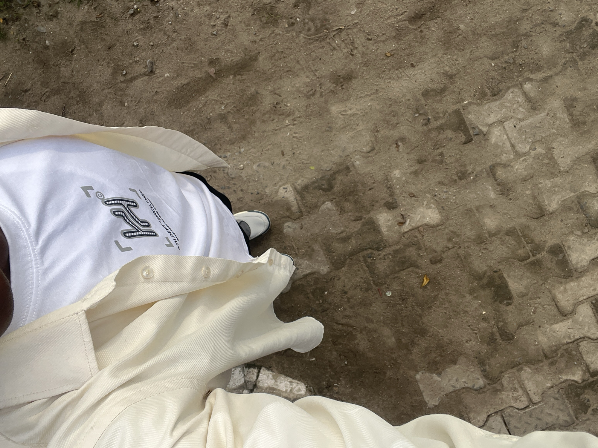 Standing on terrazzo pavement in Lagos morning