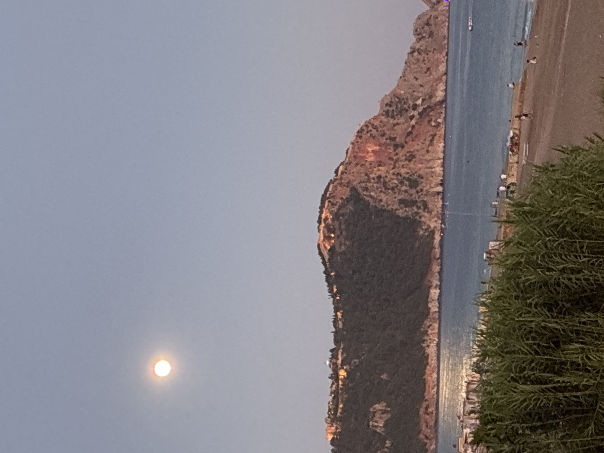 Full moon rises over Alanya's Mediterranean coastline at dusk