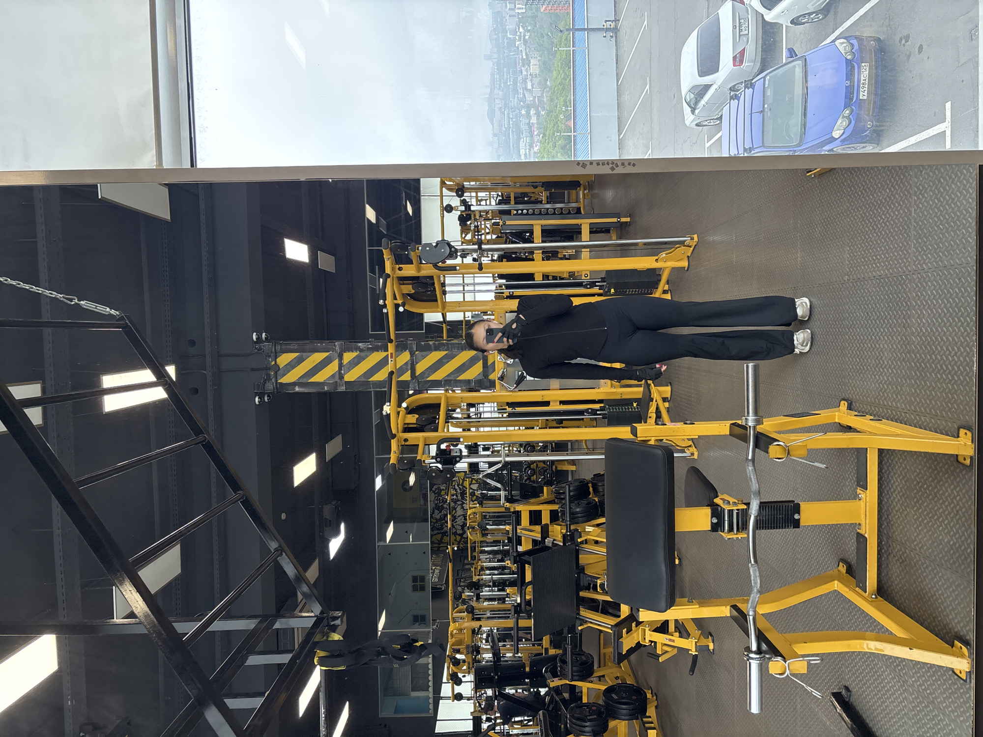 Vladivostok gym interior captured with yellow equipment, city view