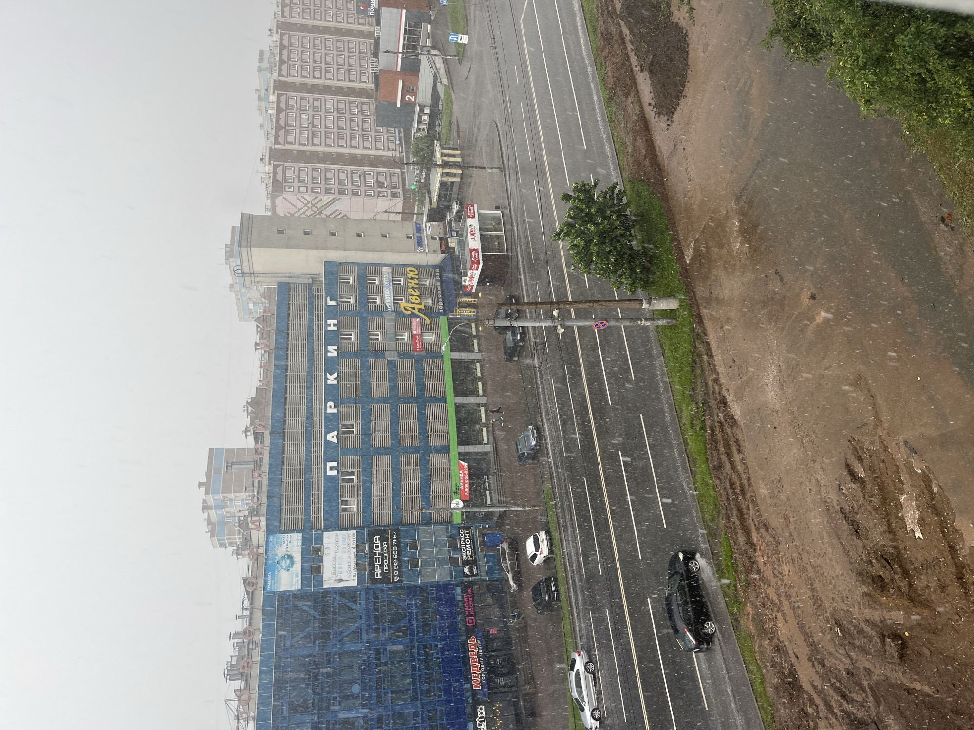 Summer rainstorm rolls through Izhevsk while people gather outside