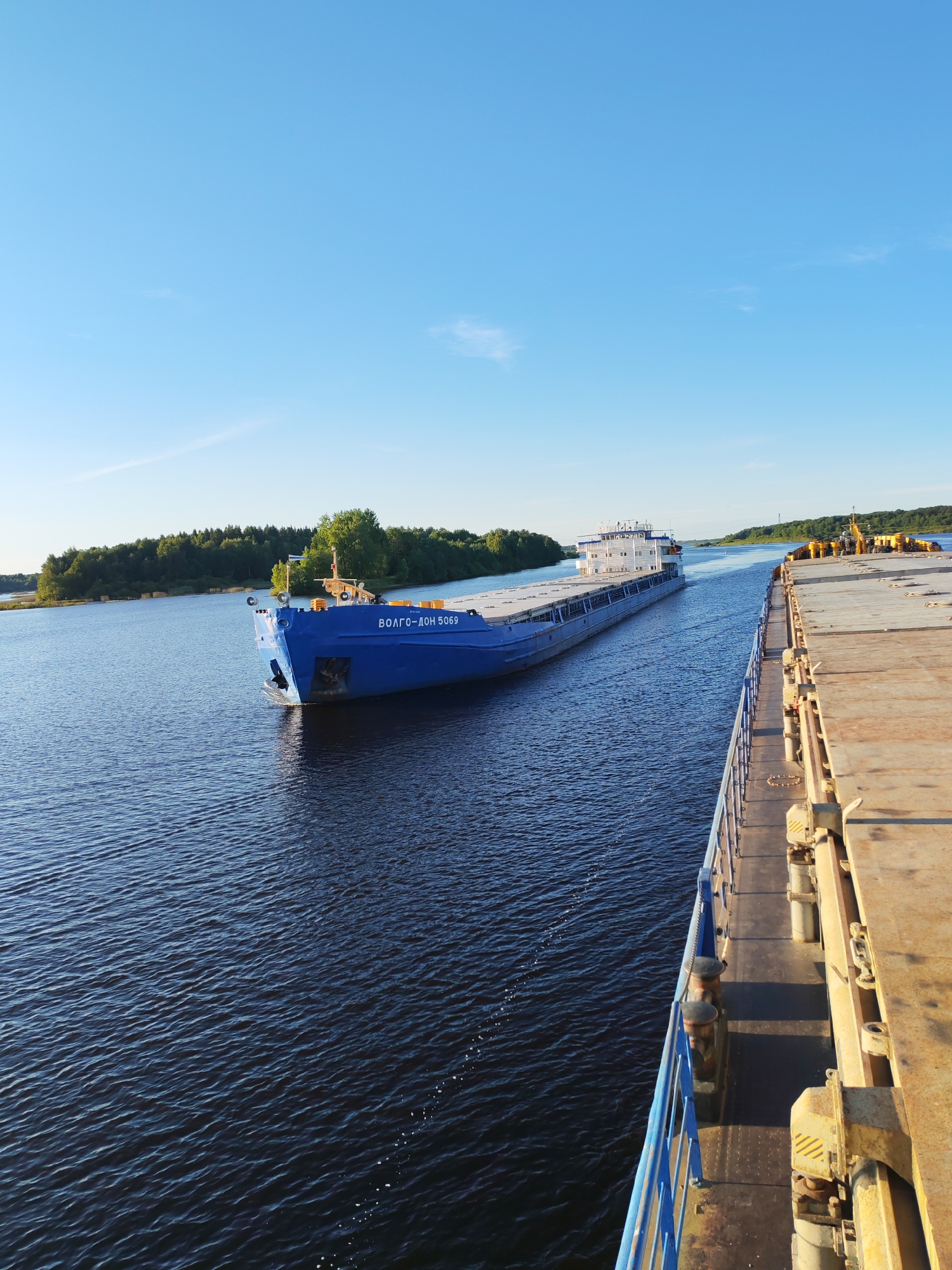 Cargo barge Volgo-Don 5069 cruises a sunny Russian river