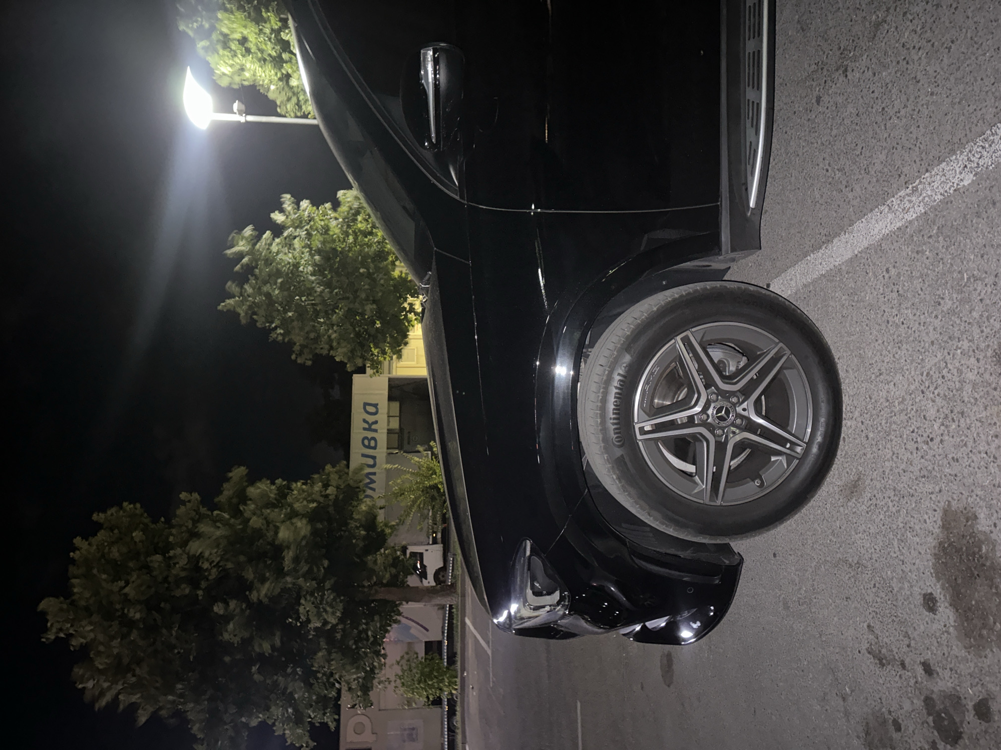 Black Mercedes GLE parked outside a Ruse car wash at night