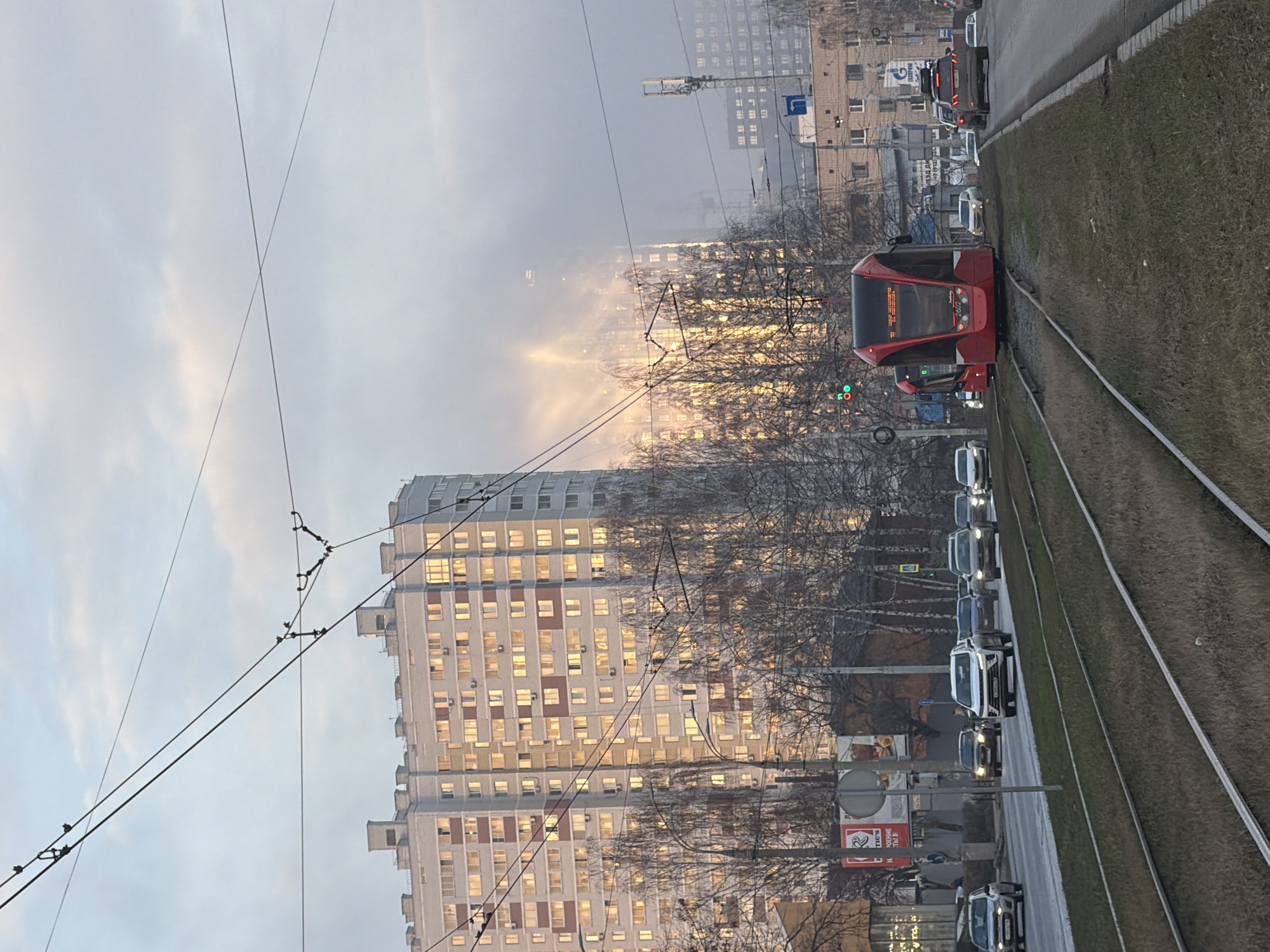 Red tram operates through hazy Izhevsk streets Friday afternoon