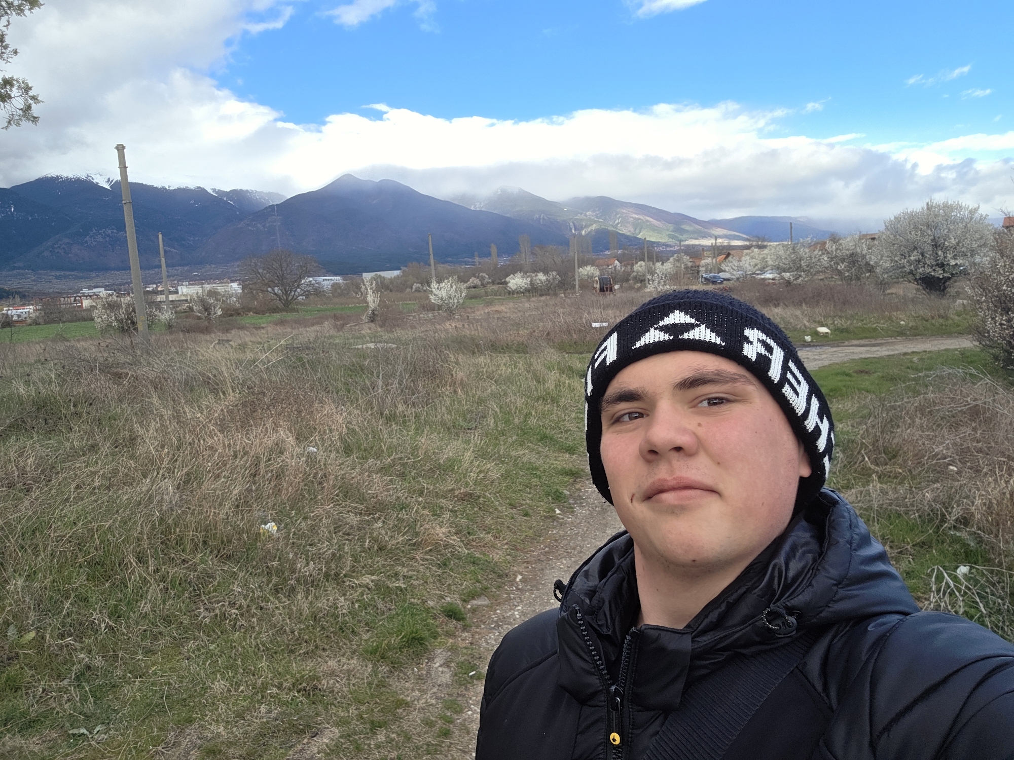 Young man takes selfie on dirt path in Yahinovo