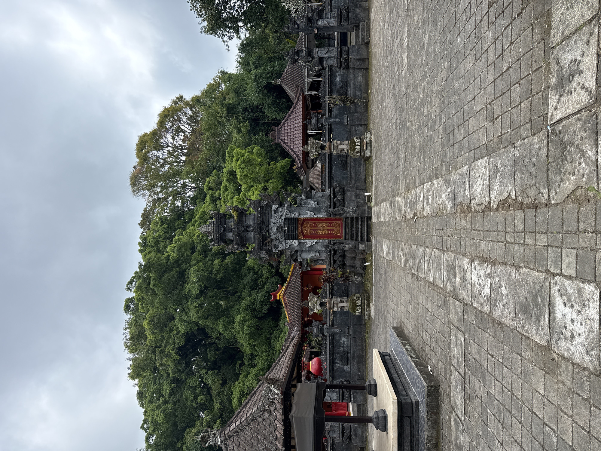 Tourist documents peaceful temple walk through Baturiti forest roads