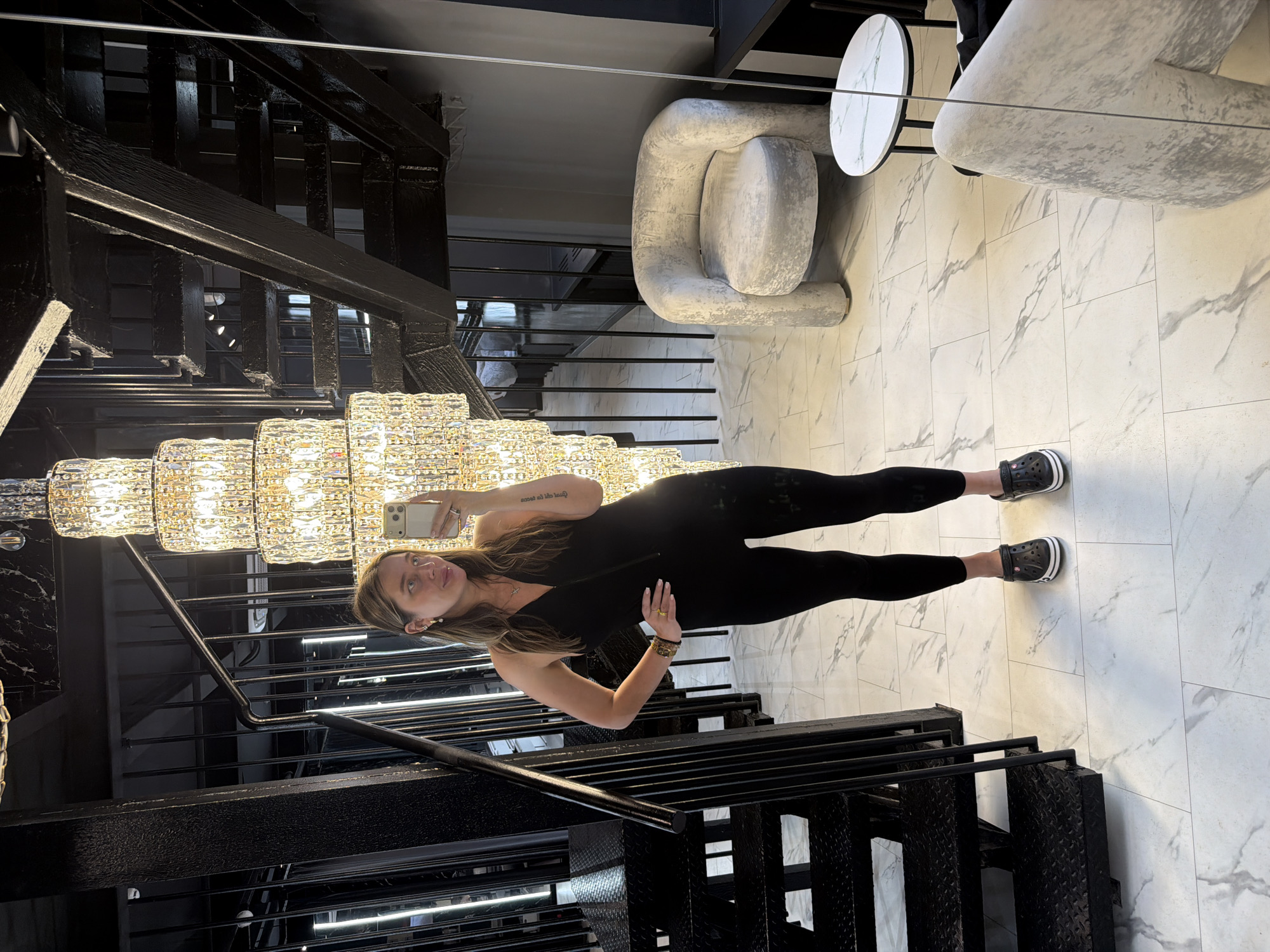 Woman takes selfies under chandelier in upscale Moscow interior