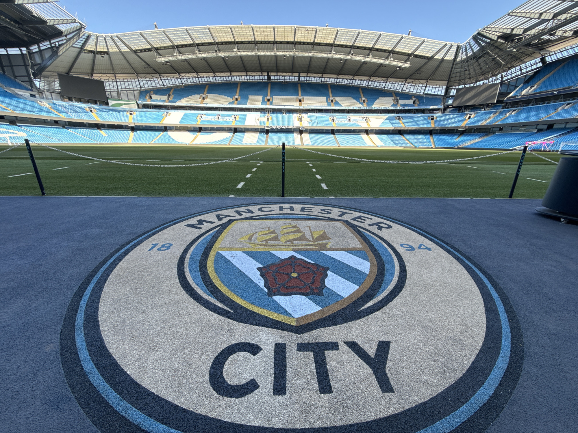 Empty Etihad Stadium captured from pitch level perspective