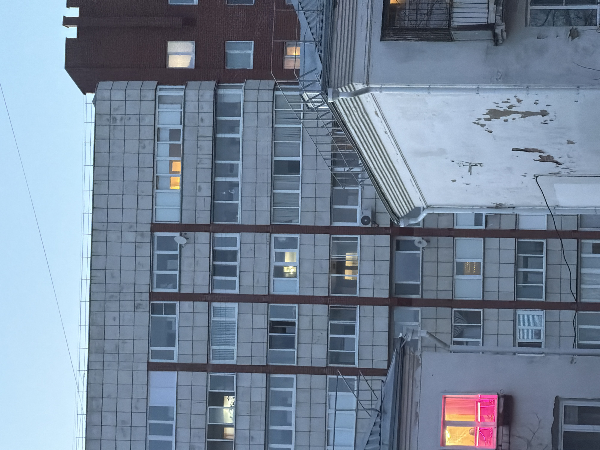 Multi-story building with lit windows observed in Perm