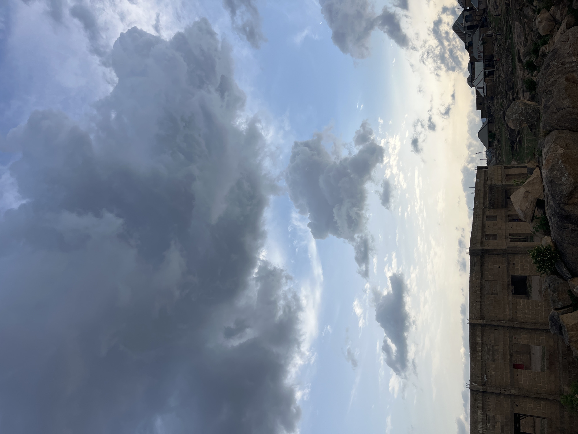 Storm clouds gather over Jos, Nigeria from rocky overlook