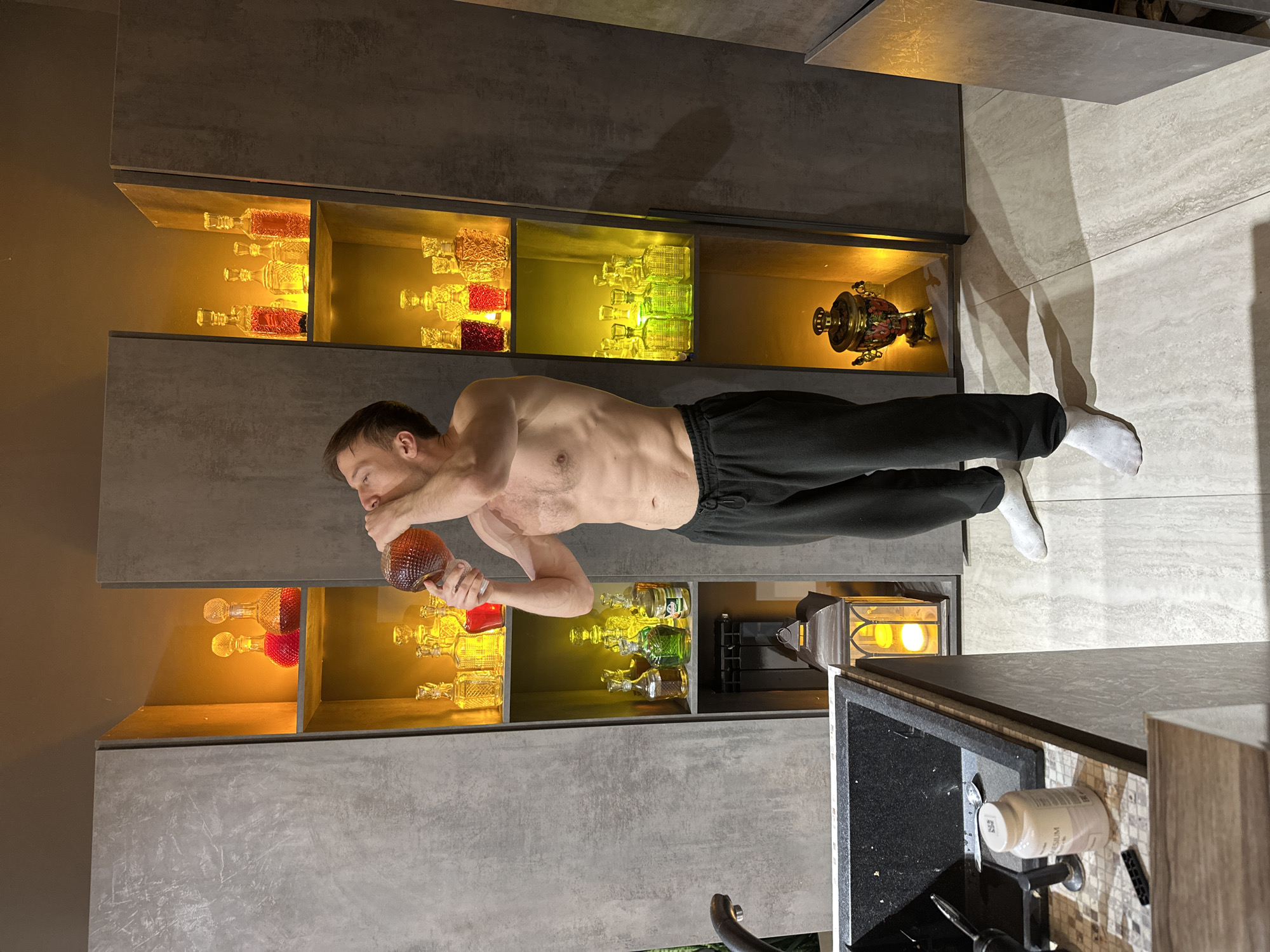 Man drinks from bottle in Kursk kitchen