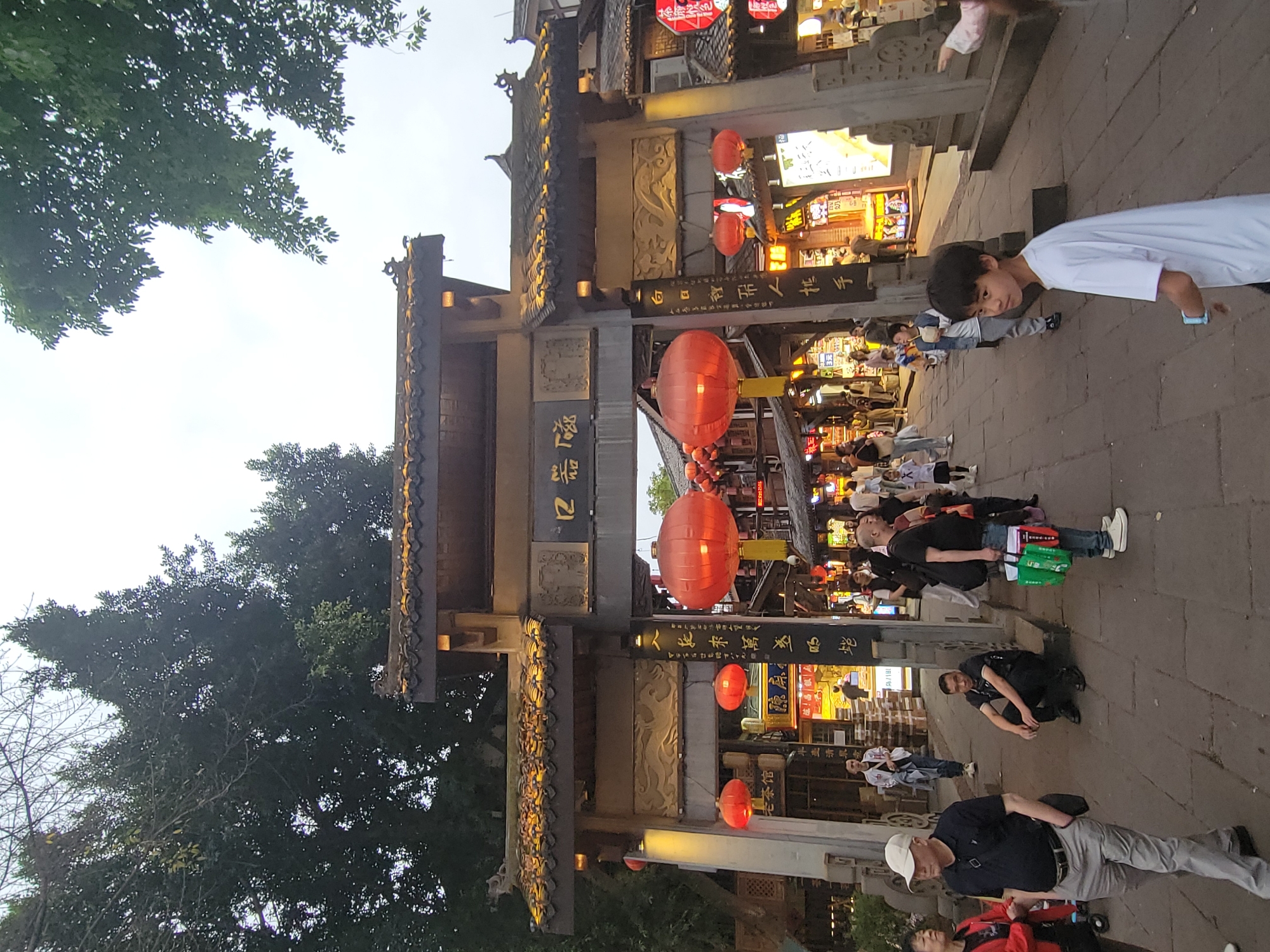 Traditional Chinese street district bustling with pedestrians and vendors