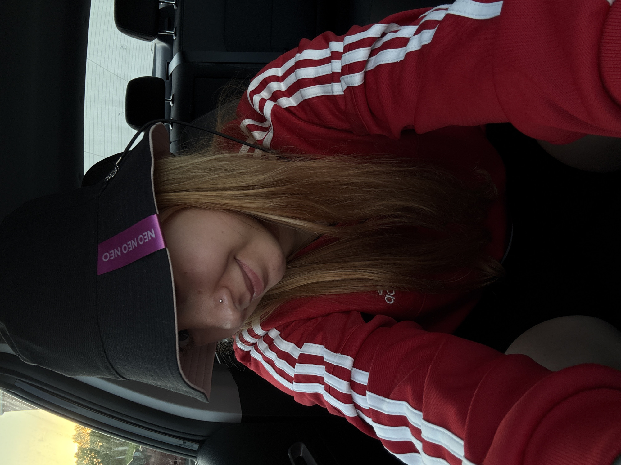 Person in tracksuit smokes cigar in Minsk parking lot