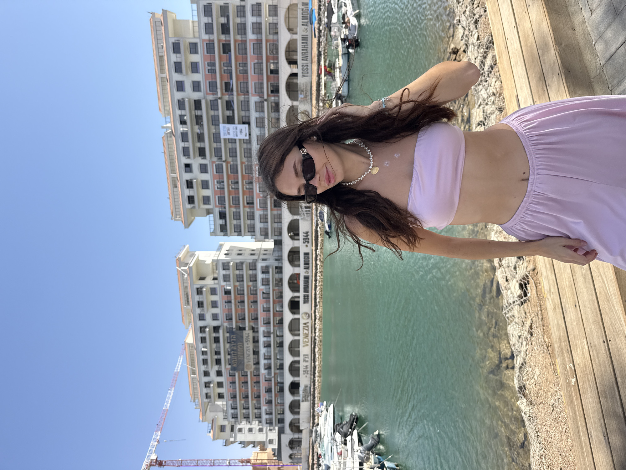 Woman poses by waterfront in Eilat, Israel