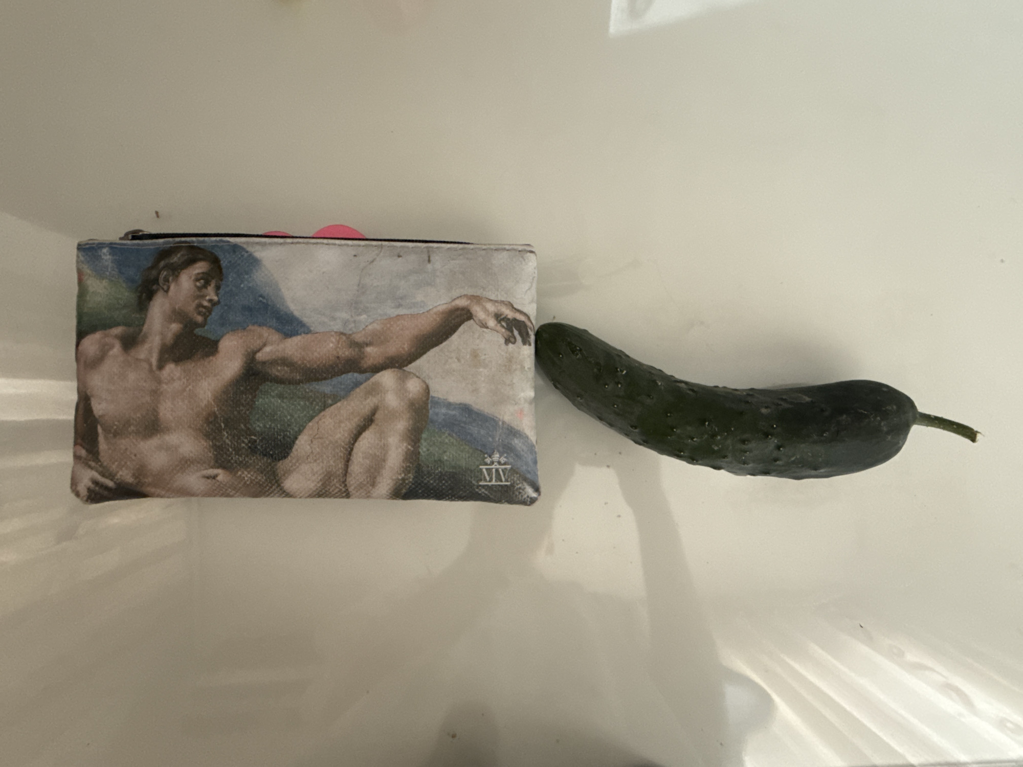 Kragujevac resident documents cluttered desk featuring cucumber and art supplies