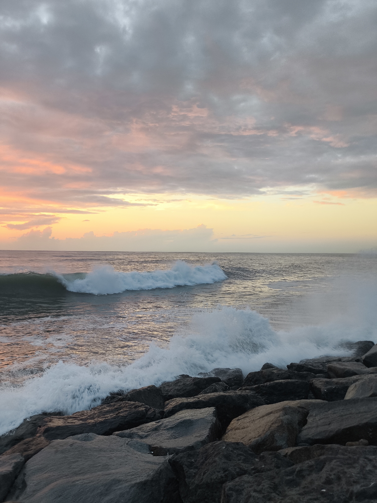 Black Sea sunset breaks over Batumi's rocky Boulevard shore