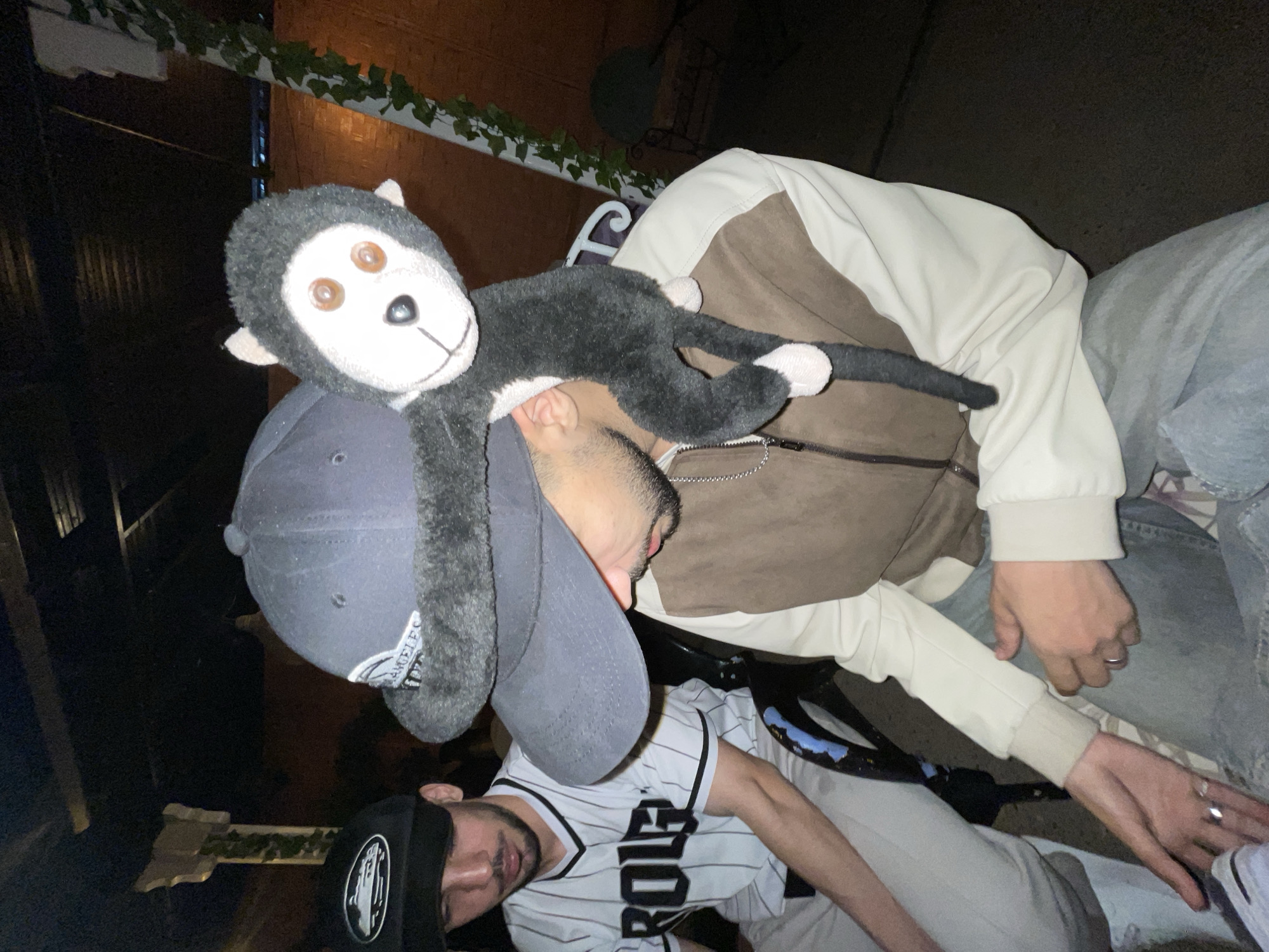 Young men spotted with stuffed monkey in Meknes evening scene