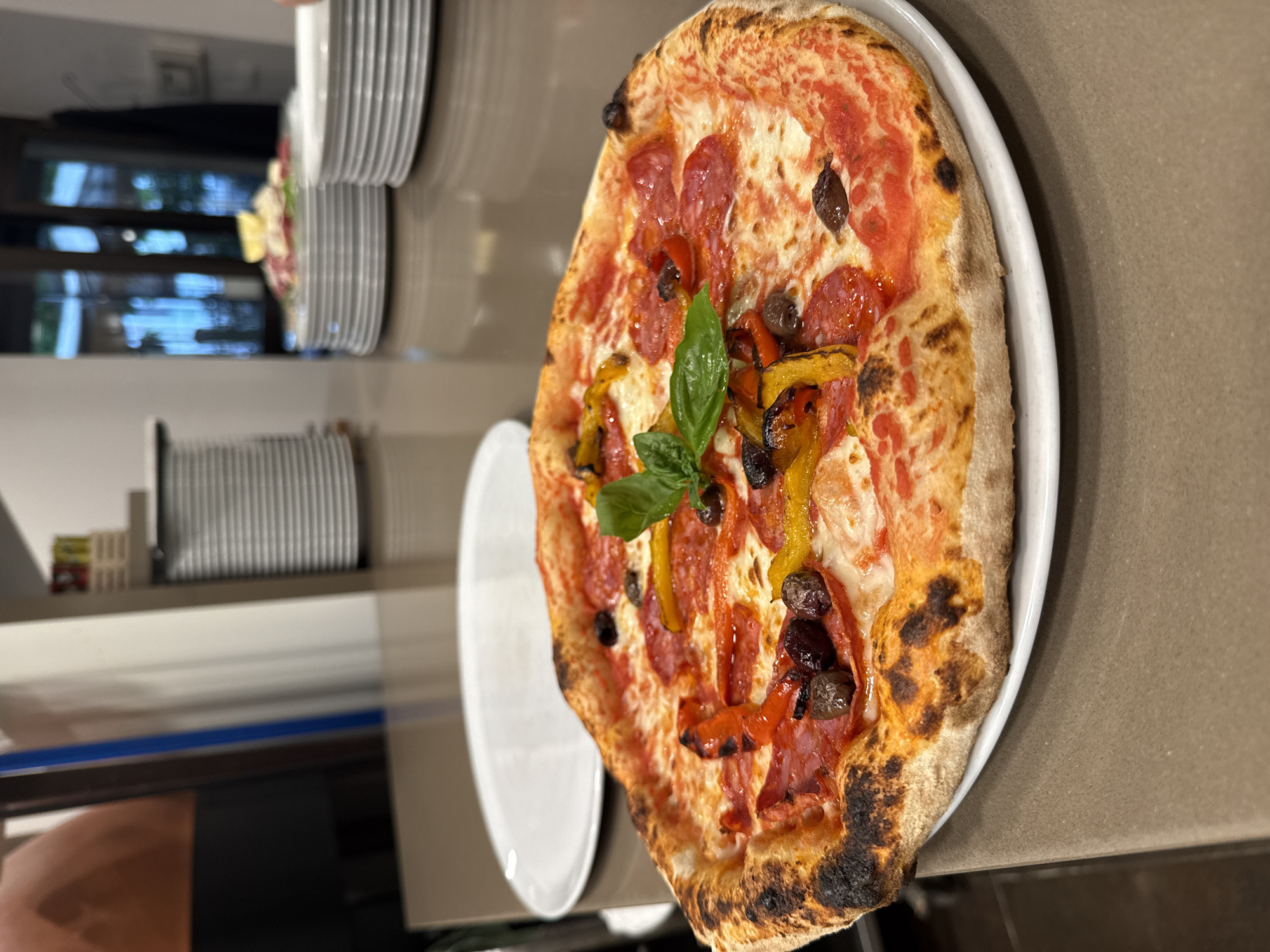 Pizza and carpaccio at a Trento restaurant, July evening