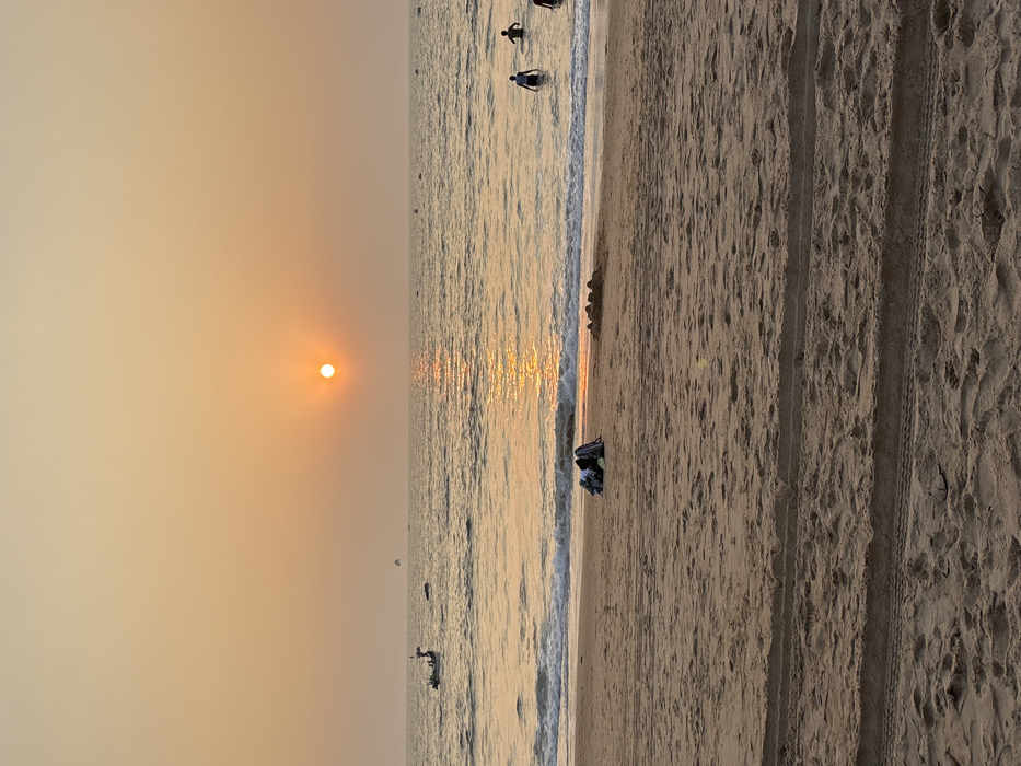 Beachgoers capture sunset moments along Indian coastline