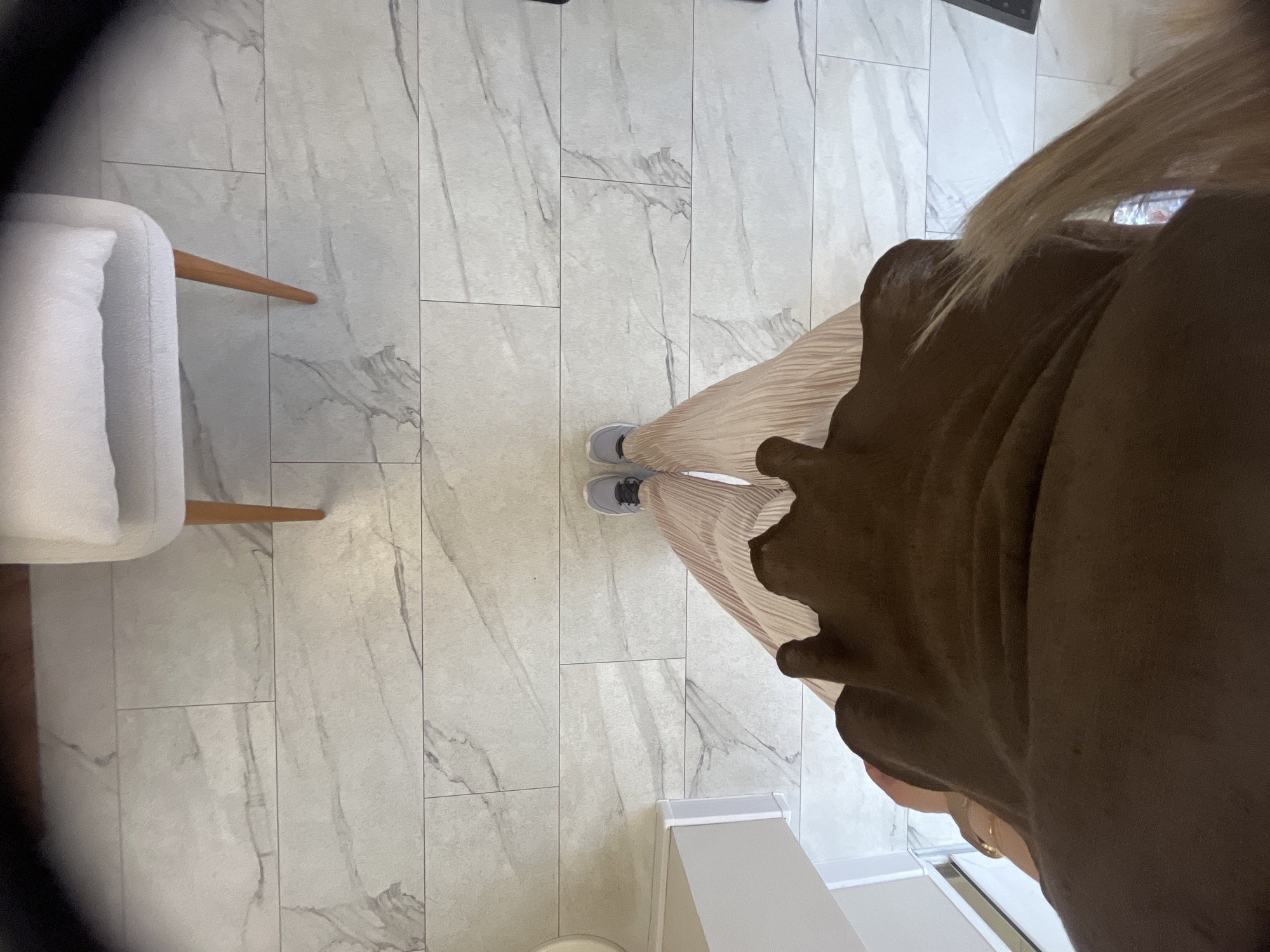 Woman documents selfie session in commercial indoor space
