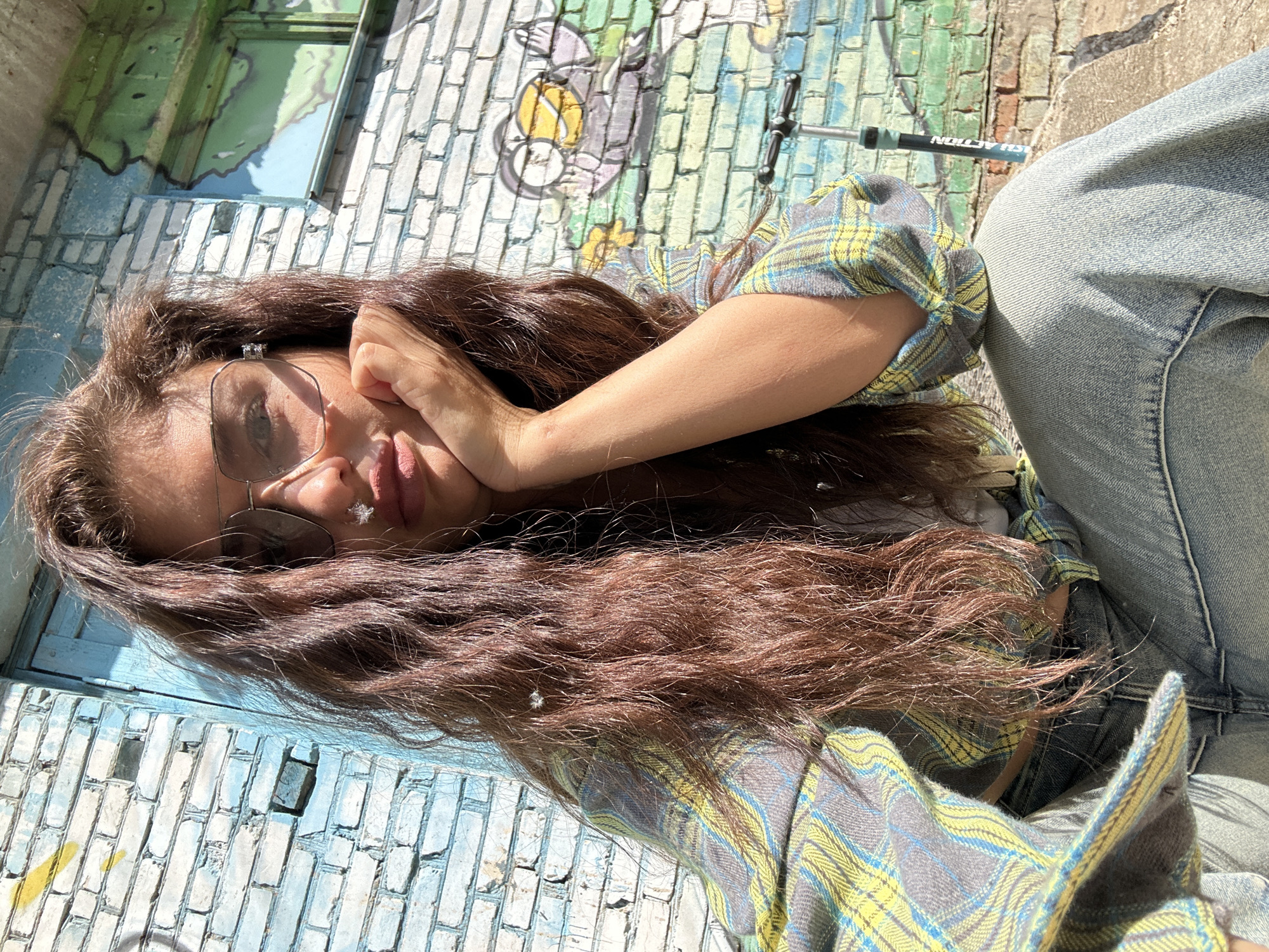 Woman resting against painted brick wall in Khimki