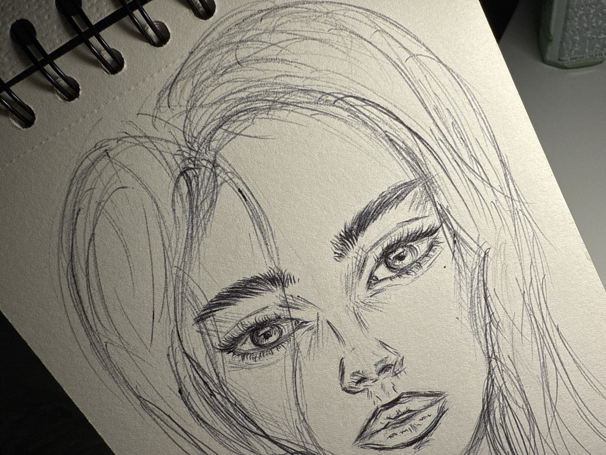 Artist sketches portraits, robots in Sofia apartment during evening session