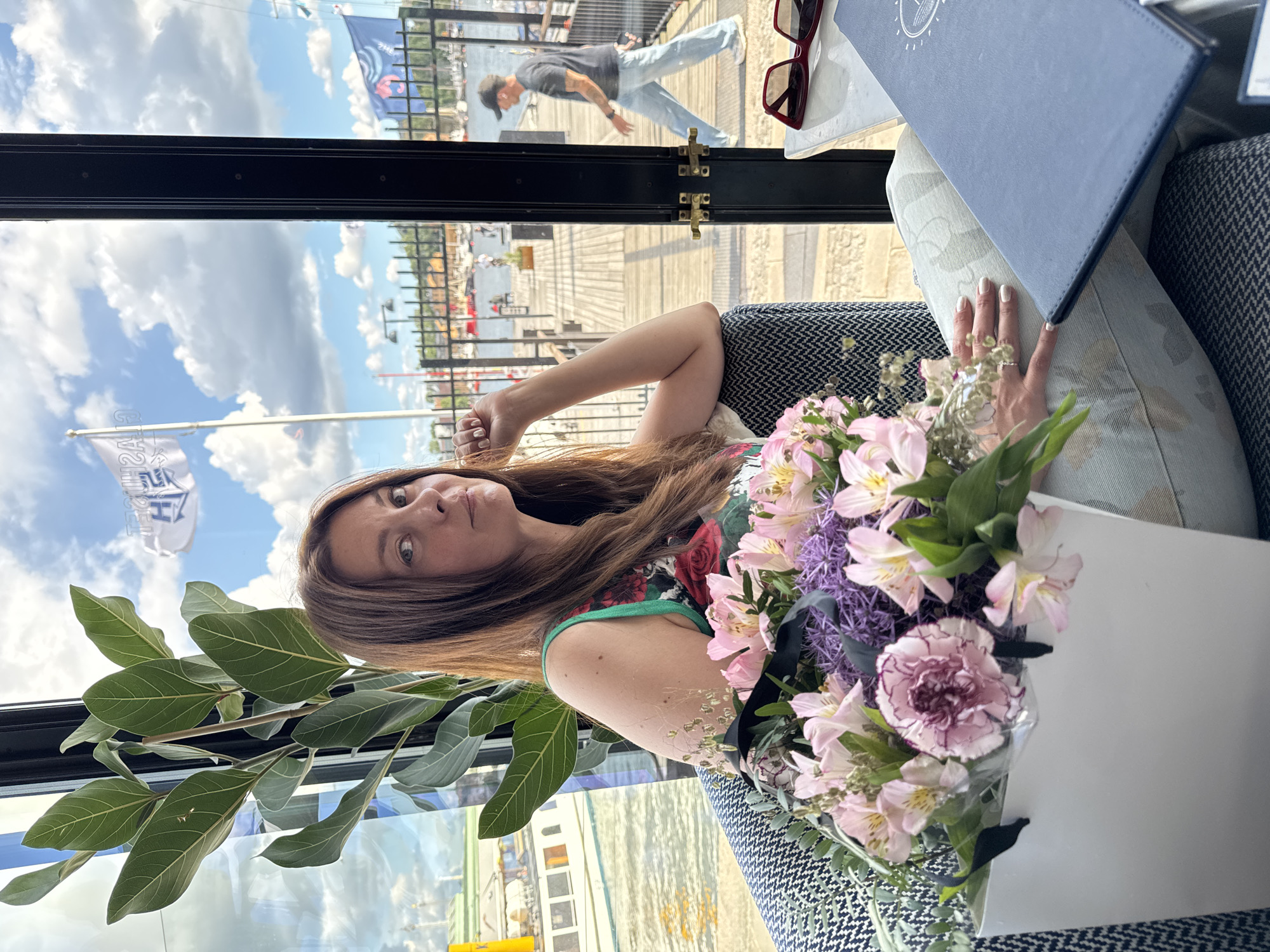 Relaxed pose in a Stockholm armchair with a bouquet nearby