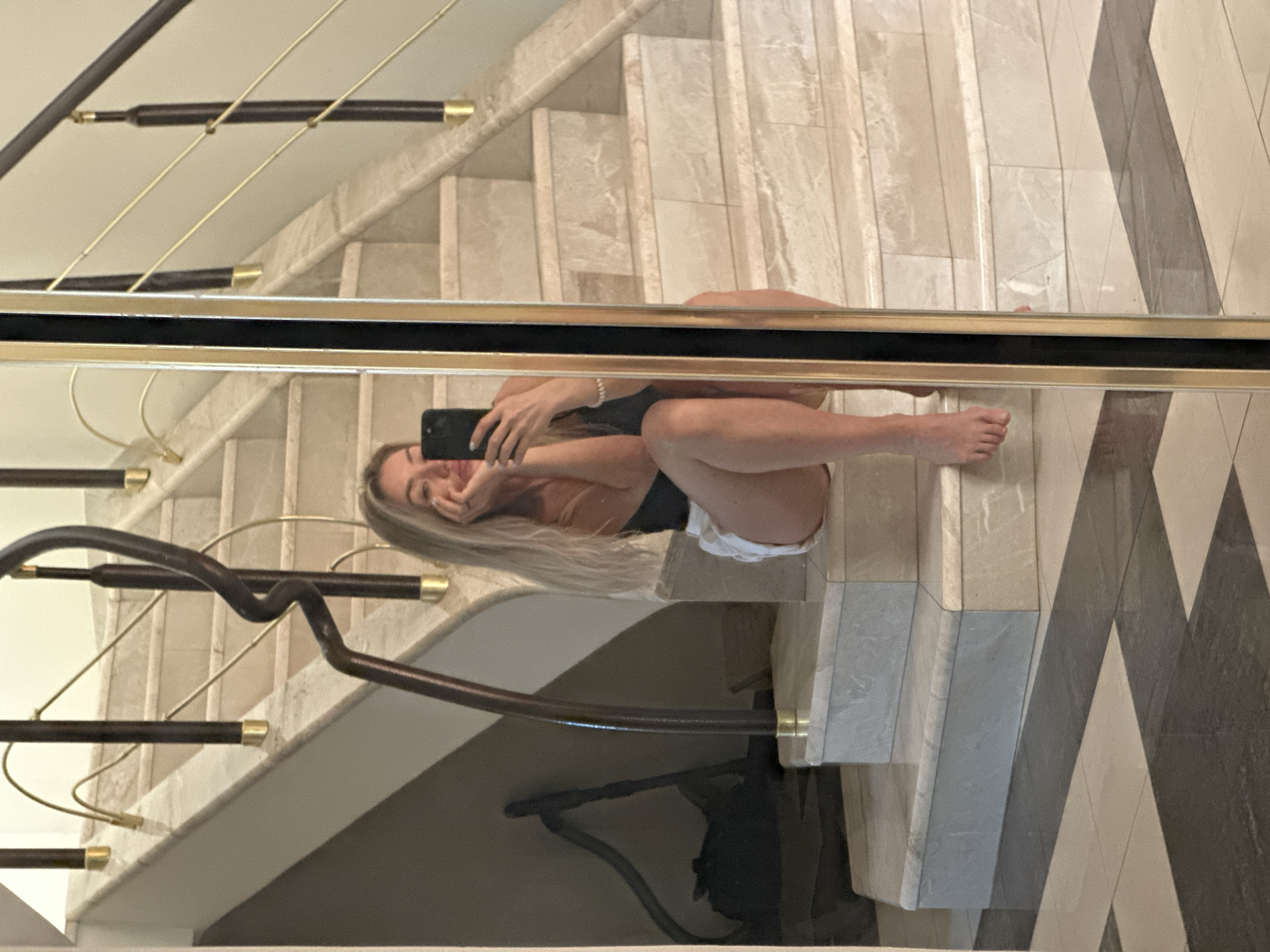 Woman takes mirror selfies with sleeping dog in Armavir home