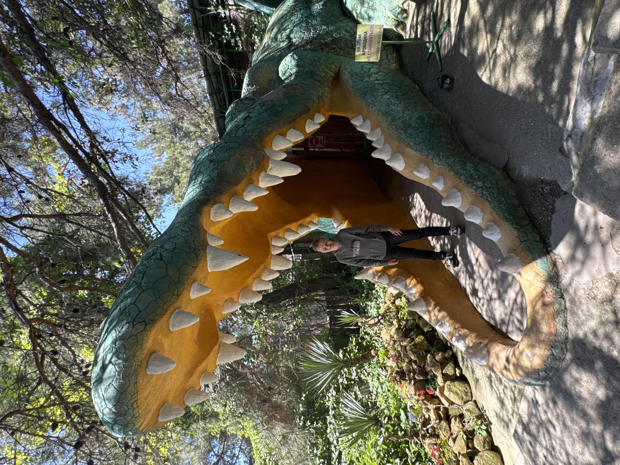 Large crocodile sculpture serves as walkway entrance for visitors