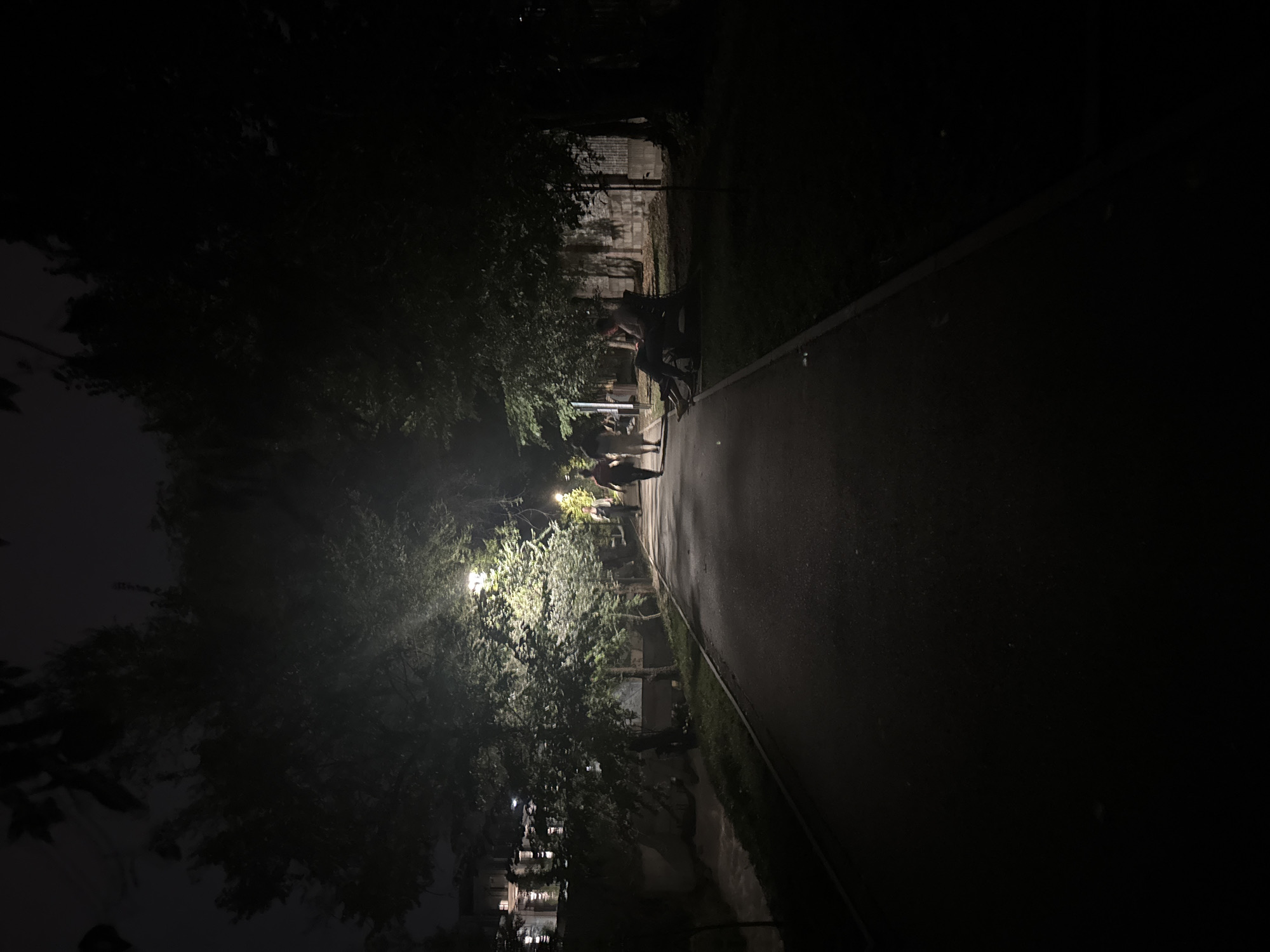 Almaty riverside boardwalk and pedestrian bridge at night