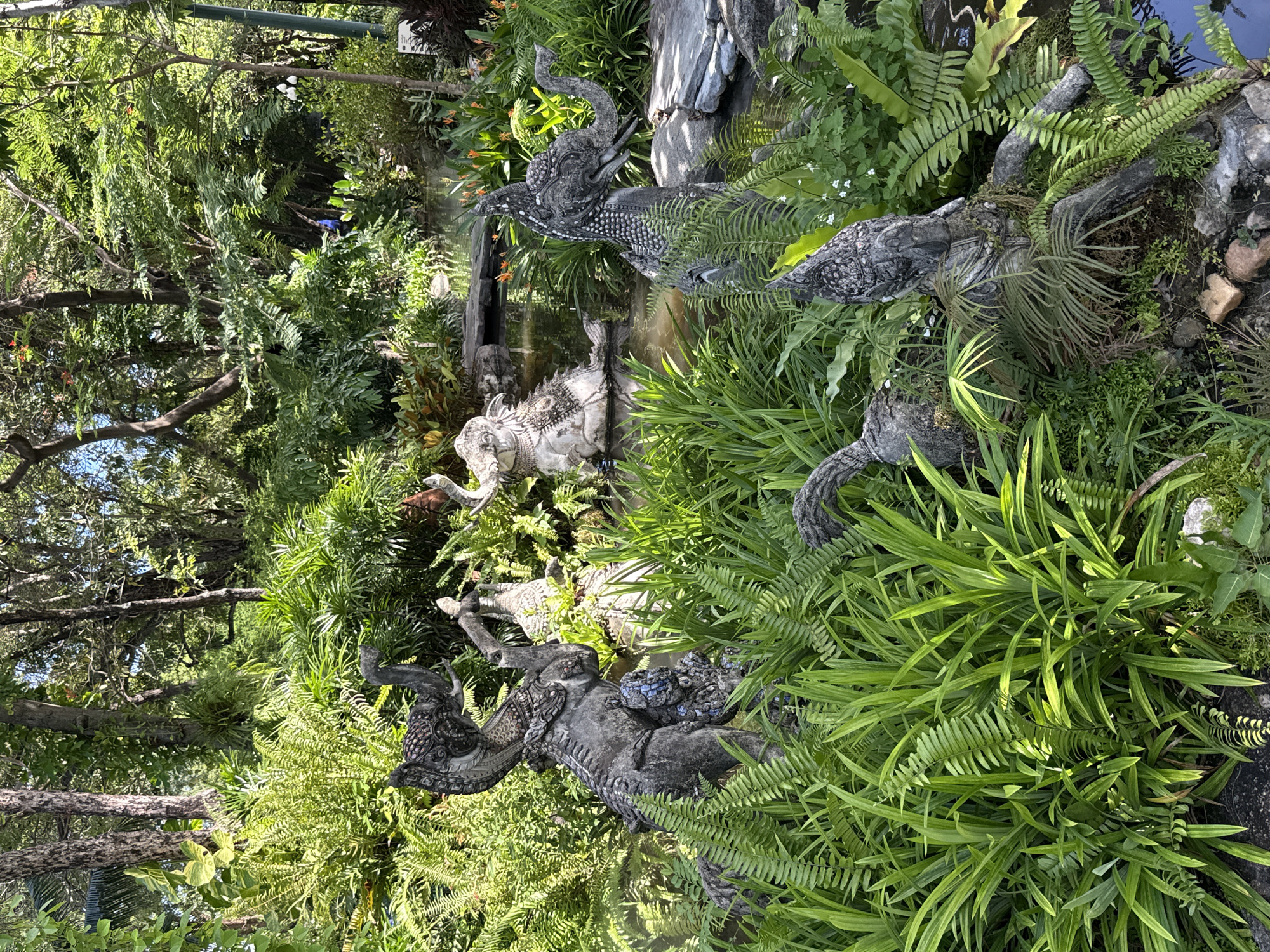 Ornamental garden with elephant statues, peacock sculptures documented in Thailand