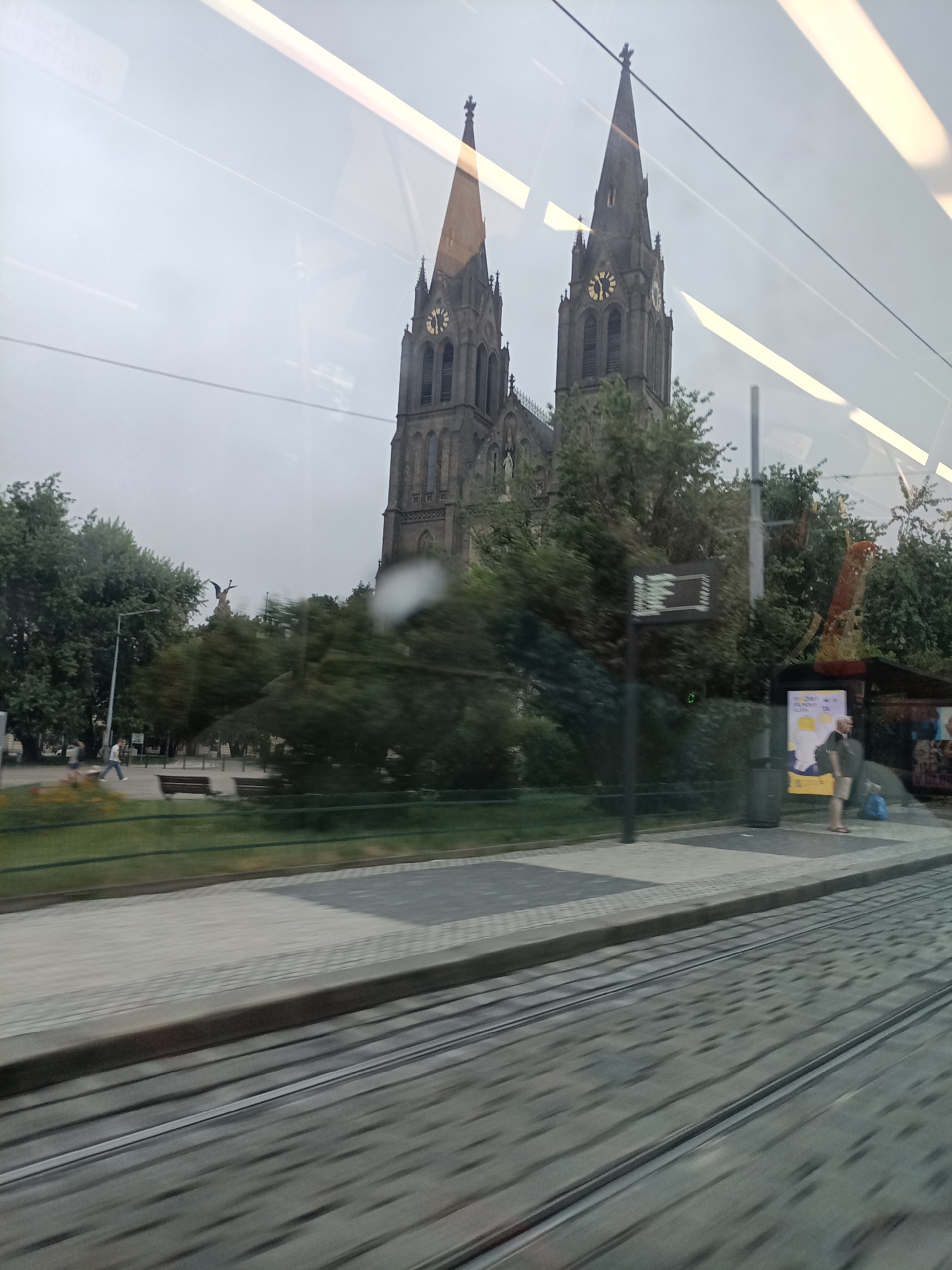 Tram window views of Prague's Gothic landmarks on a grey morning