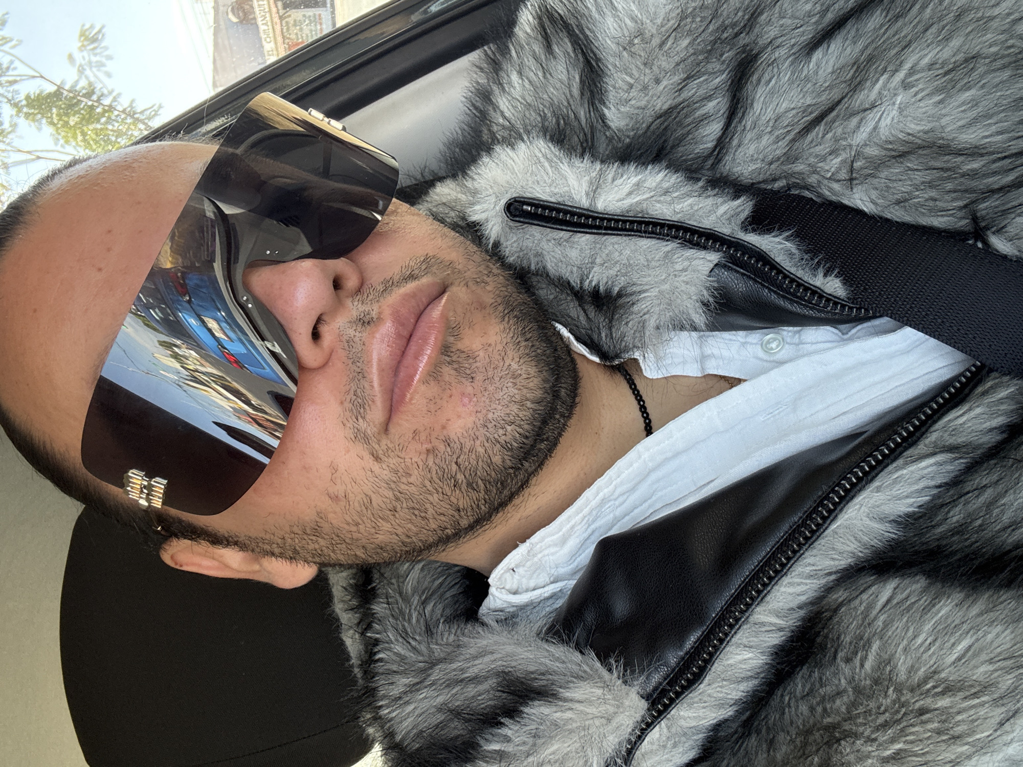 Man in fur coat and sunglasses spotted in car
