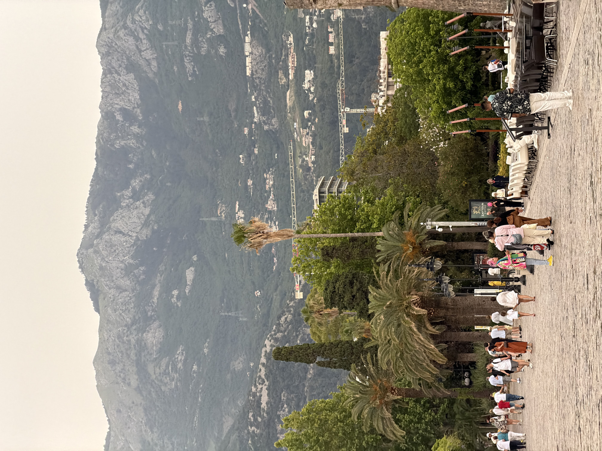 Tourist documents historic and modern Budva during afternoon walk