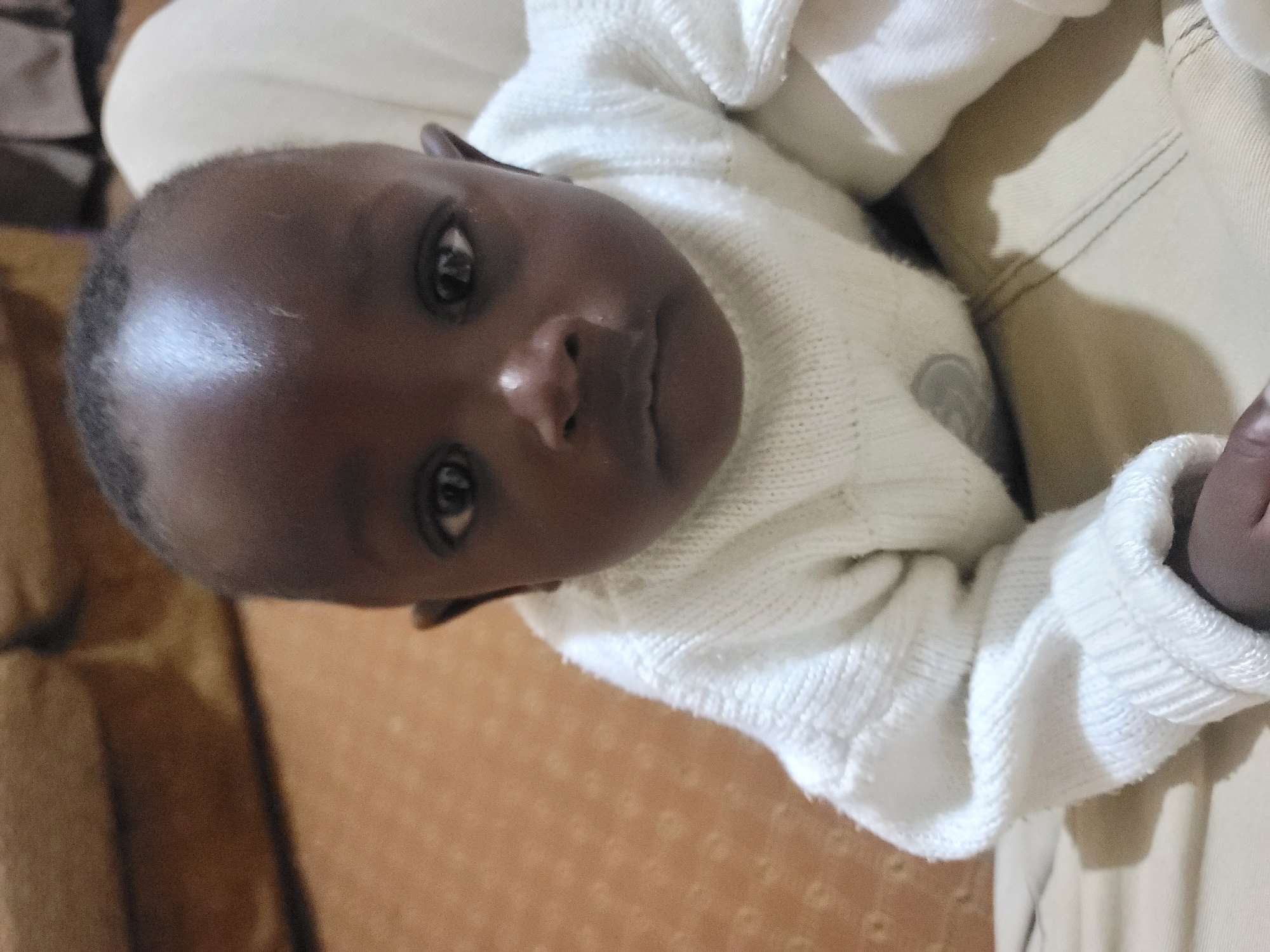 Indoor portrait session with child in white sweater