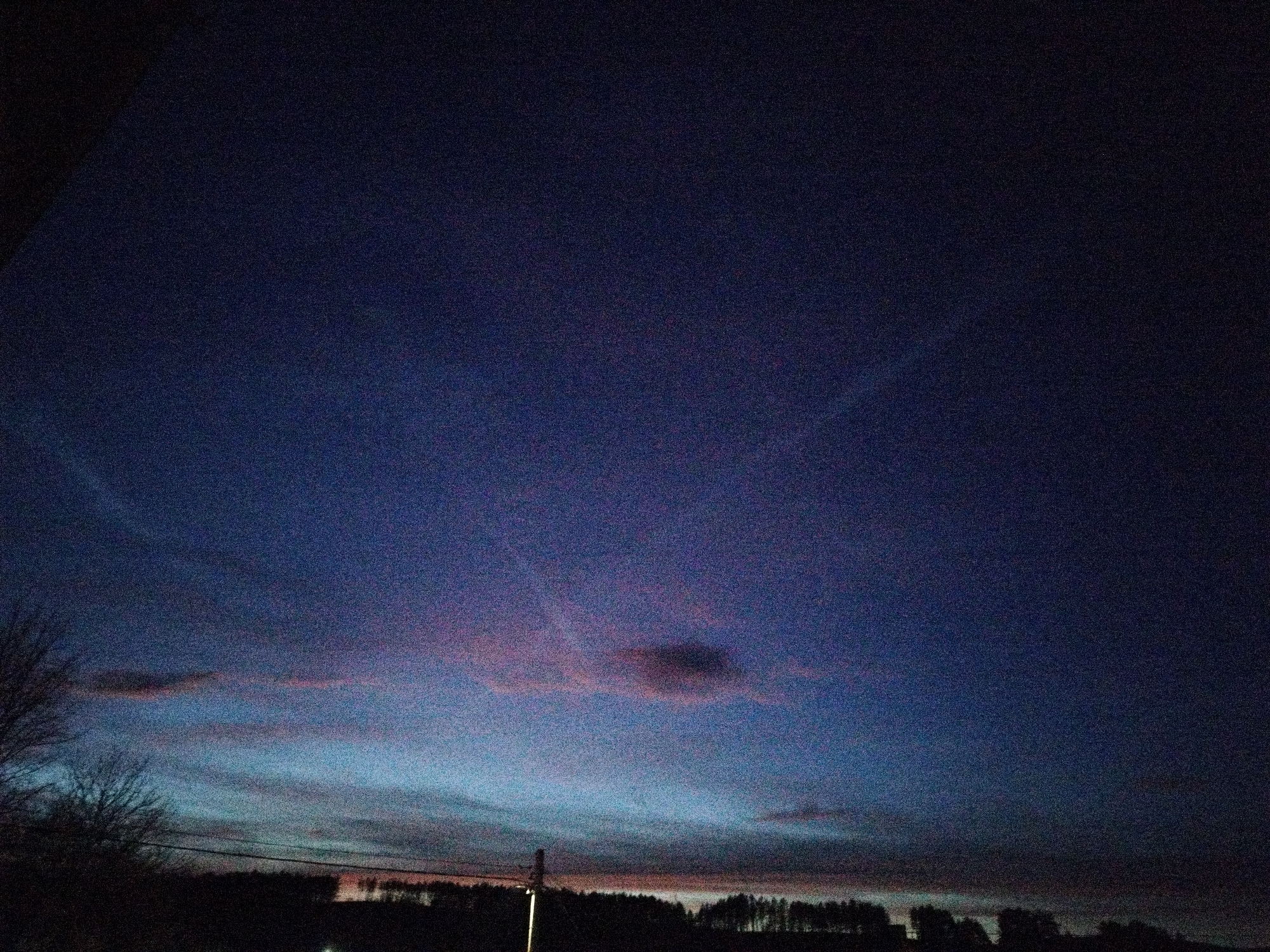 Twilight sky photographed over silhouetted landscape during evening hours